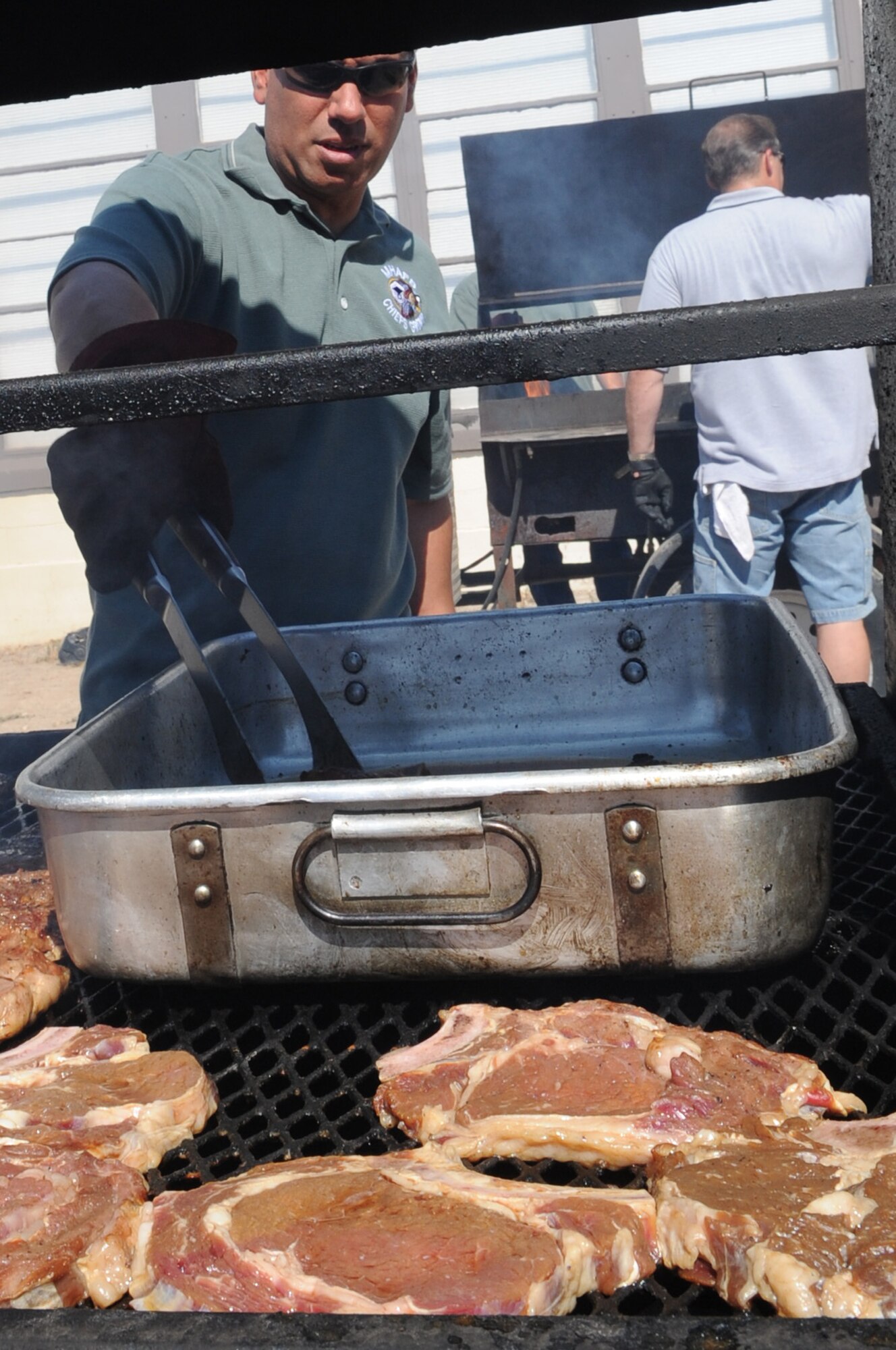 MOUNTAIN HOME AIR FORCE BASE, Idaho -- Chief Master Sgt. Leonardo Rodriguez, 726th Air Control Squadron chief enlisted manager, places a cooked steak into a serving pan during a Chief’s Steak Burn Aug 18. The Chief’s Steak Burn is held seven times during the summer months and the funds are used to assist different organizations on base. (U.S. Air Force photo by Senior Airman Roy Lynch)