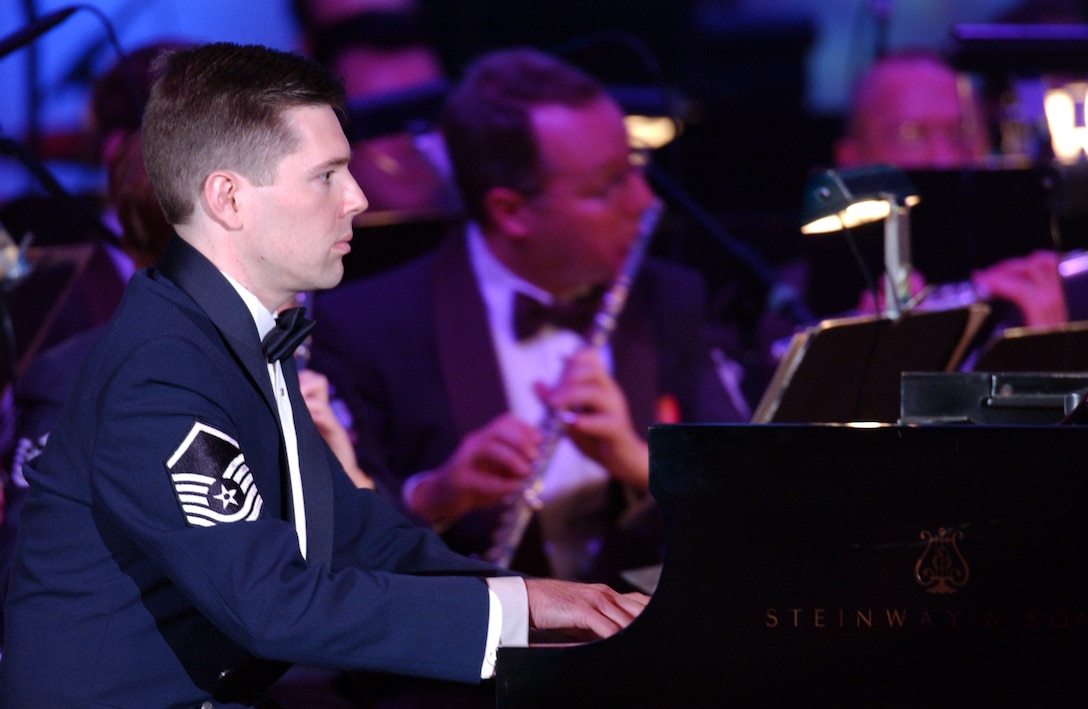 Master Sgt. John Bliss, Staff Arranger and Composer for The USAF Band, performs his composition "Fresh Powder" at the Daughters of the American Revolution Constitution Hall in 2003. A native of Fremont, Calif., Sergeant Bliss joined the Air Force in 1996 as a member of the arranging staff for the United States AIr Force Band of the Golden West at Travis Air Force Base, Calif.  He joined the music production staff of The USAF Band in 1998.