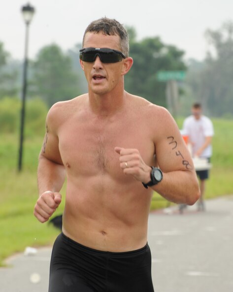 LAKE PARK, Ga. -- Chief Master Sgt. Richard Parsons, 23rd Wing command chief from Moody Air Force Base, Ga., maintains his stride after a drink of water during the first mile of the 3.1 mile Sprint course in the Winnersville Sprint and Titletown Olympic Triathlon here Aug. 22. Chief Parsons placed second in the 40-44 age category with a total time of 1:27:50.0. (U.S. Air Force photo/Master Sgt. Stan Coleman)
