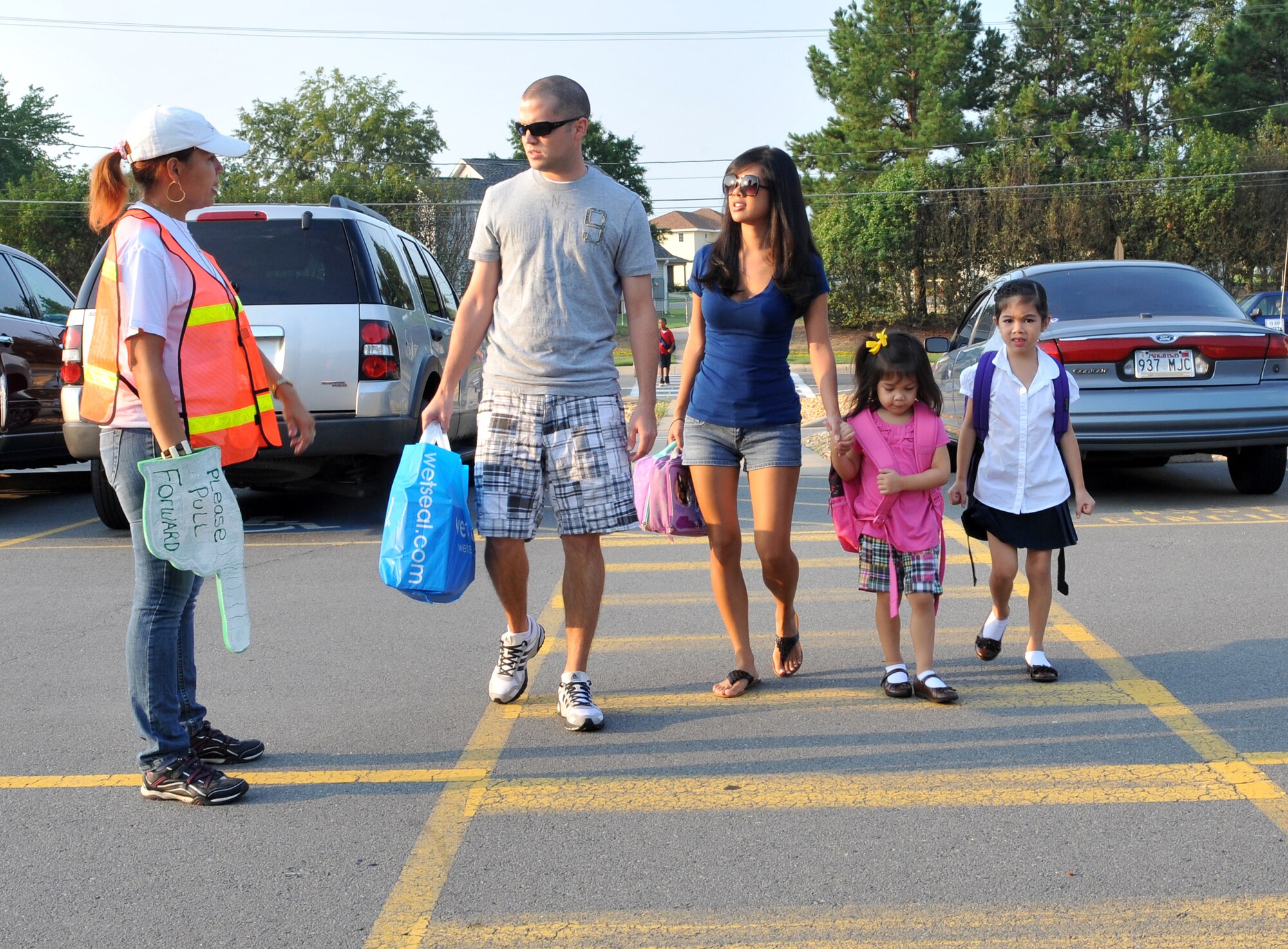 Staff Sgt. Christopher Whitten, 53rd Airlift Squadron flight engineer, and wife, Mechelle, walk daughters, Avalyn (left), 4; and Kaylee (right), 6; to school Aug. 19 with the help of a crossing guard. Crossing guards are posted at Arnold Drive Elementary School from 7:30 to 8:30 a.m. and from 3:50 to 4:15 p.m. to ensure the safety of the children crossing the streets. (U.S. Air Force photo by Staff Sgt. Chris Willis)