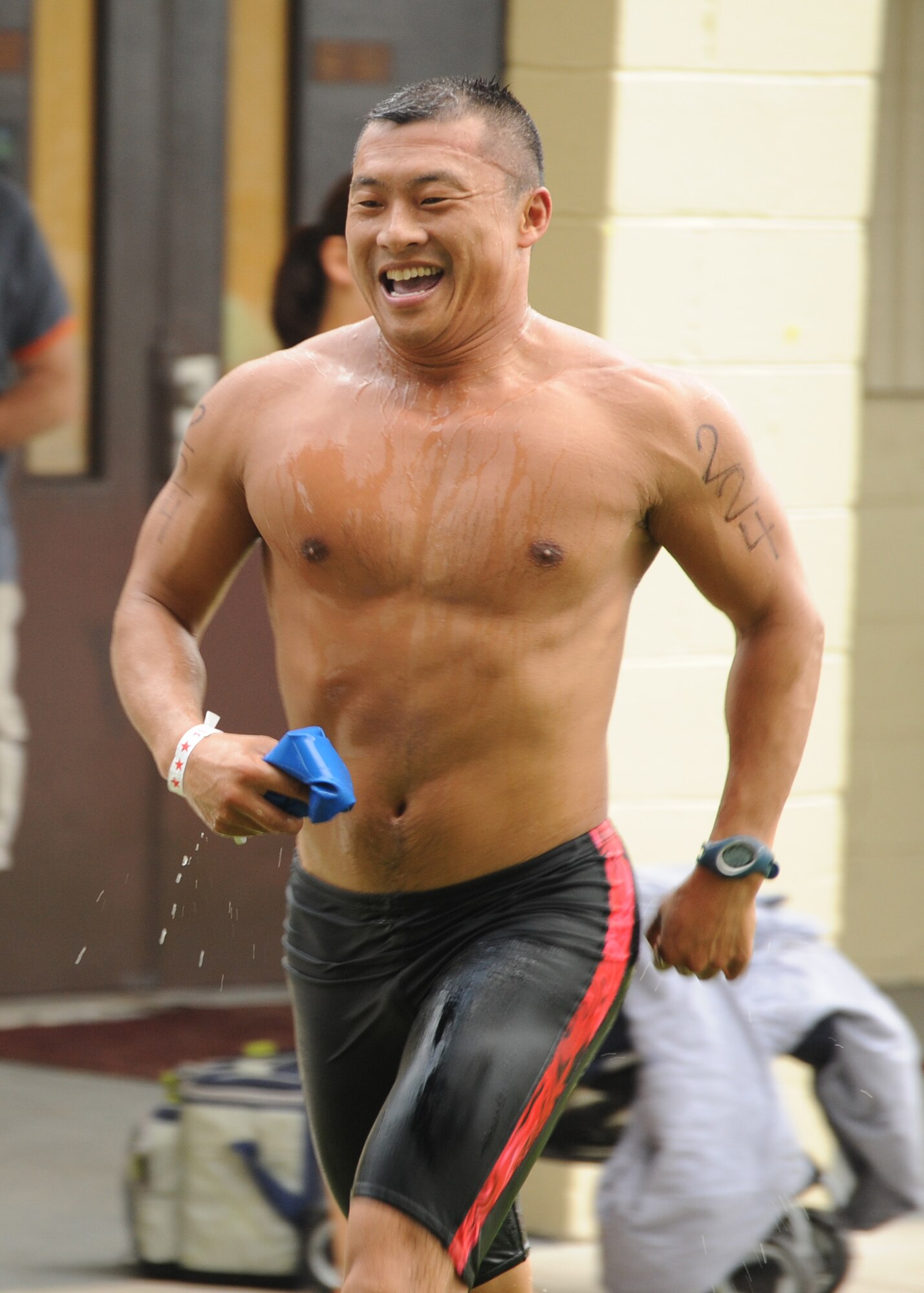 LAKE PARK, Ga. -- Master Sgt. Sam Louie, 820th Combat Operations Squadron from Moody Air Force Base, Ga., wet from completing the 1000-yard swim, runs toward the bicycle holding area to continue the Olympic course during the Winnersville Sprint and Titletown Olympic Triathlon here Aug. 21. The Olympic course consisted of a 1000-yard swim, 27-mile bike and 6.2 mile run. Sergeant Louie placed fifth in the 40 to 44 age category with a total time of 2:35:59.  (U.S. Air Force/Master Sgt. Stan Coleman)
