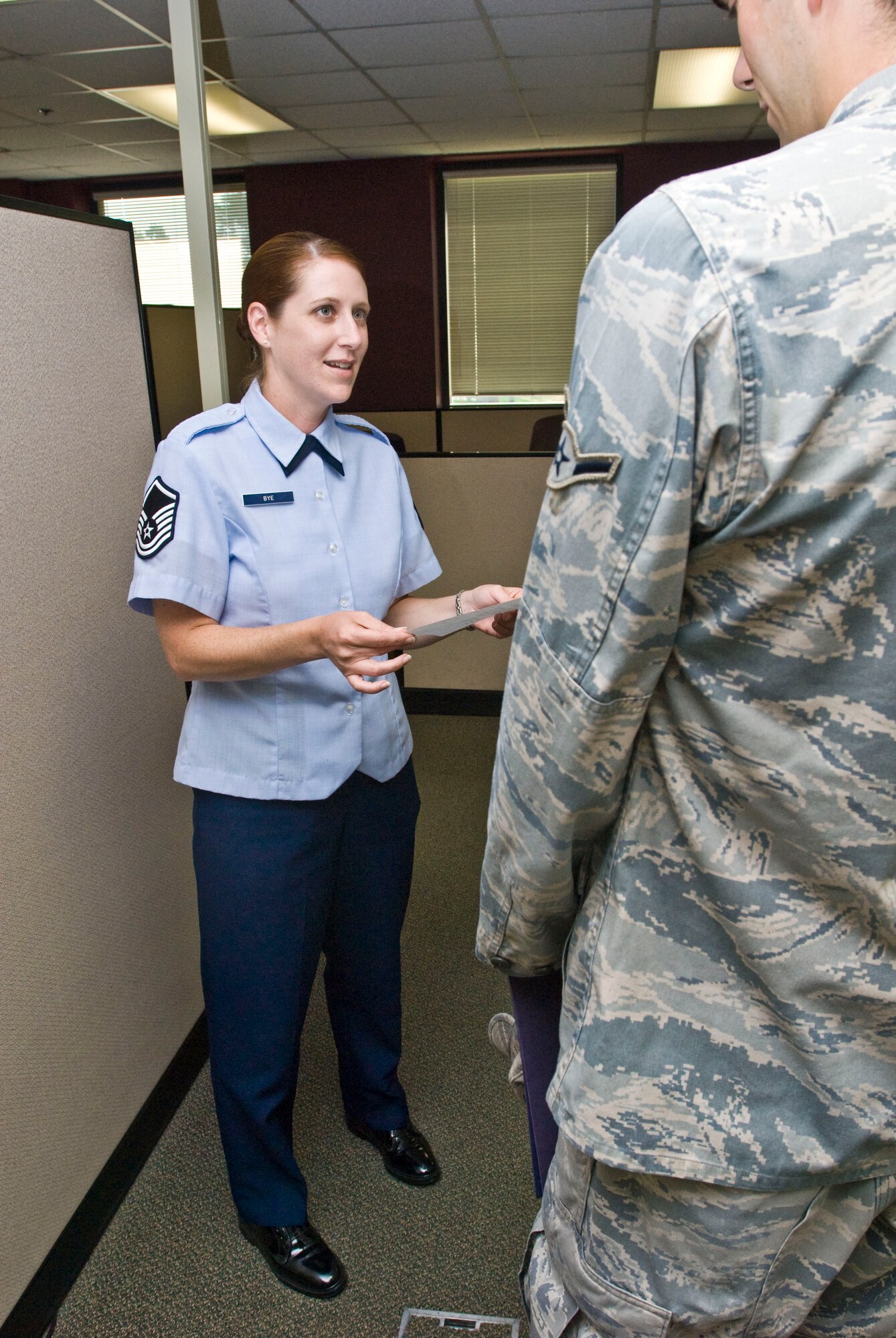 Master Sgt. Jennifer Bye, 19th Force Support Squadron career development superintendent, assists an Airman with his retainability paperwork for PCS Aug. 16. The New Albany, Ind., native provides customer support to more than 250 career-development customers every week. (U.S. Air Force photo by Staff Sgt. Nestor Cruz)
