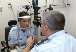 Maj. (Dr.) Michael Osterhoudt, 633d Aerospace Medicine Squadron, performs an eye exam on Tech. Sgt. Melkys Richards, 633 AMDS, at the USAF Hospital Langley Optometry Clinic Aug. 23. August is Cataract Awareness Month, and Airmen are advised to protect their eyes against ultraviolet rays and see their optometrist normally to reduce the risk of cataract formation. (U.S. Air Force photo/Airman 1st Class Jason J. Brown)