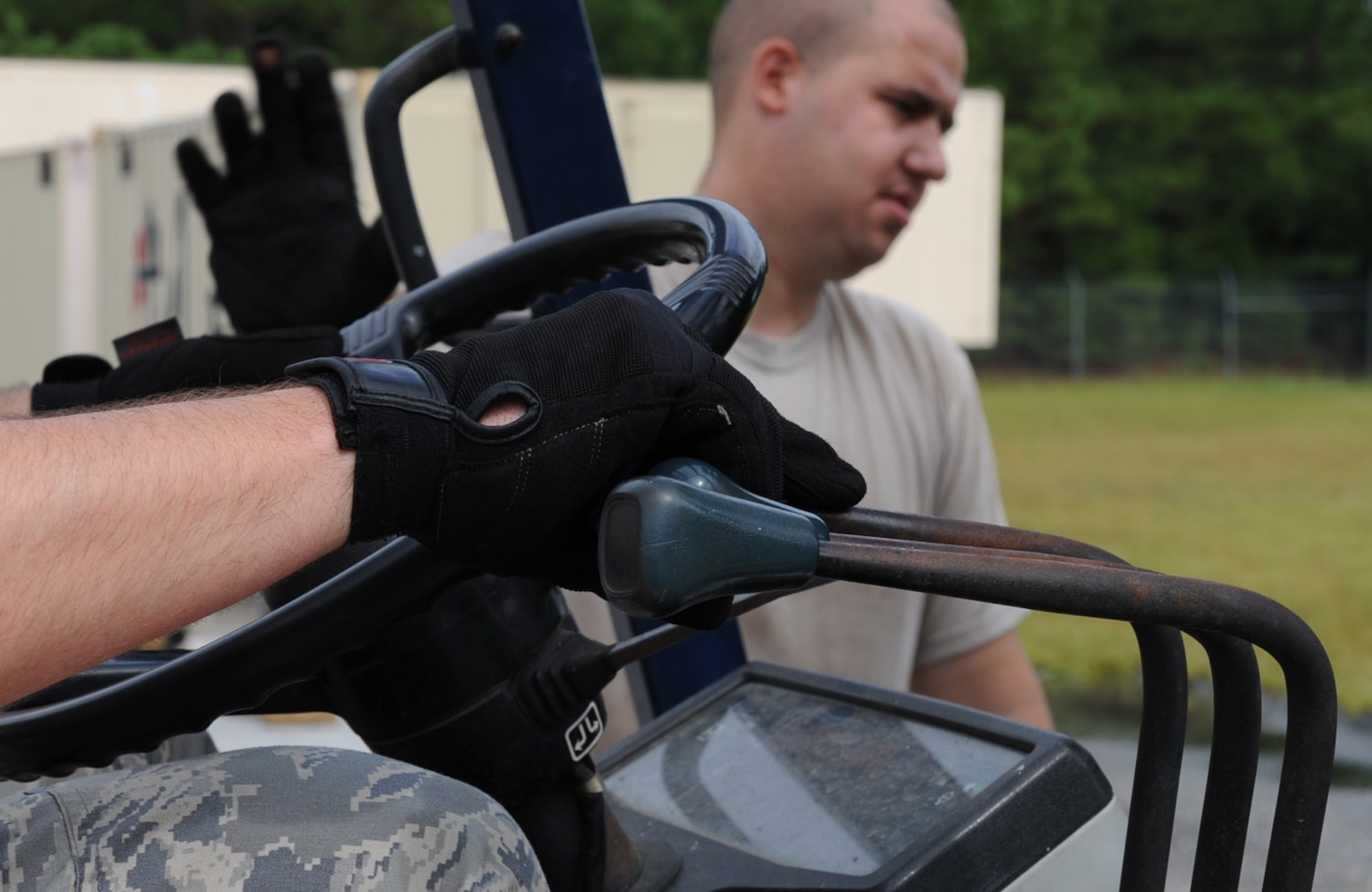 GOLDSBORO, N.C. -- Tech. Sgt. Brian Miller operates a fork lift while loading a pallet as Staff Sgt. Dennis Chambers directs his movements at the MERCI Mission Center Aug. 20, 2010. The Airmen helped the MERCI Center staff sort and pallet donated goods for shippment to Afghanistan. Sergeant Miller, 4th Logistic Readiness Squadron mission readiness spare package NCOIC, hails from Auburndale, Fla. Sergeant Chambers, 4th LRS air transportation technician, is a native of Ashtabula, Ohio. (U.S. Air Force photo/Senior Airman Gino Reyes)