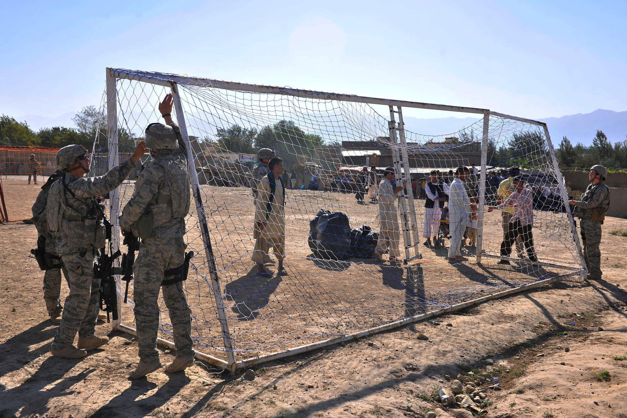 Members of the 455th Expeditionary Security Forces Squadron set up a soccer net outside of Bagram Airfield, Afghanistan, Aug. 22, 2010. The 455th ESFS compiled soccer equipment donated by the Future Business Leaders of America chapter at Desert Hills High School in Gilbert, Ariz., and distributed as part of a community strengthening program between the coalition forces and the Afghan people. (U.S. Air Force photo/Staff Sgt. Christopher Boitz)