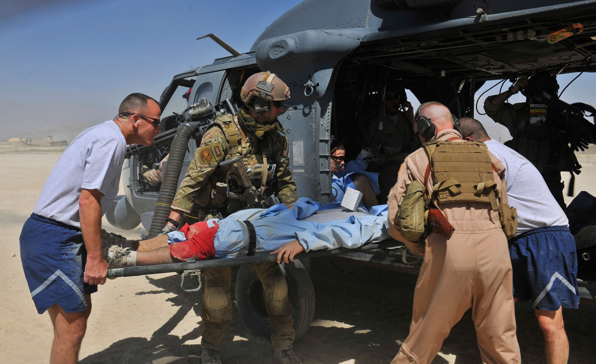 Pararecuemen and ground forces personnel load simulated wounded on to an HH-60G Pave Hawk helicopter for medical extraction during an exercise at Bagram Airfield, Afghanistan, Aug. 21. 2010. The exercise tested the rescue squadron?s ability to provide medical aid to U.S. and Coalition forces. (U.S. Air Force photo/Staff Sgt. Christopher Boitz) 