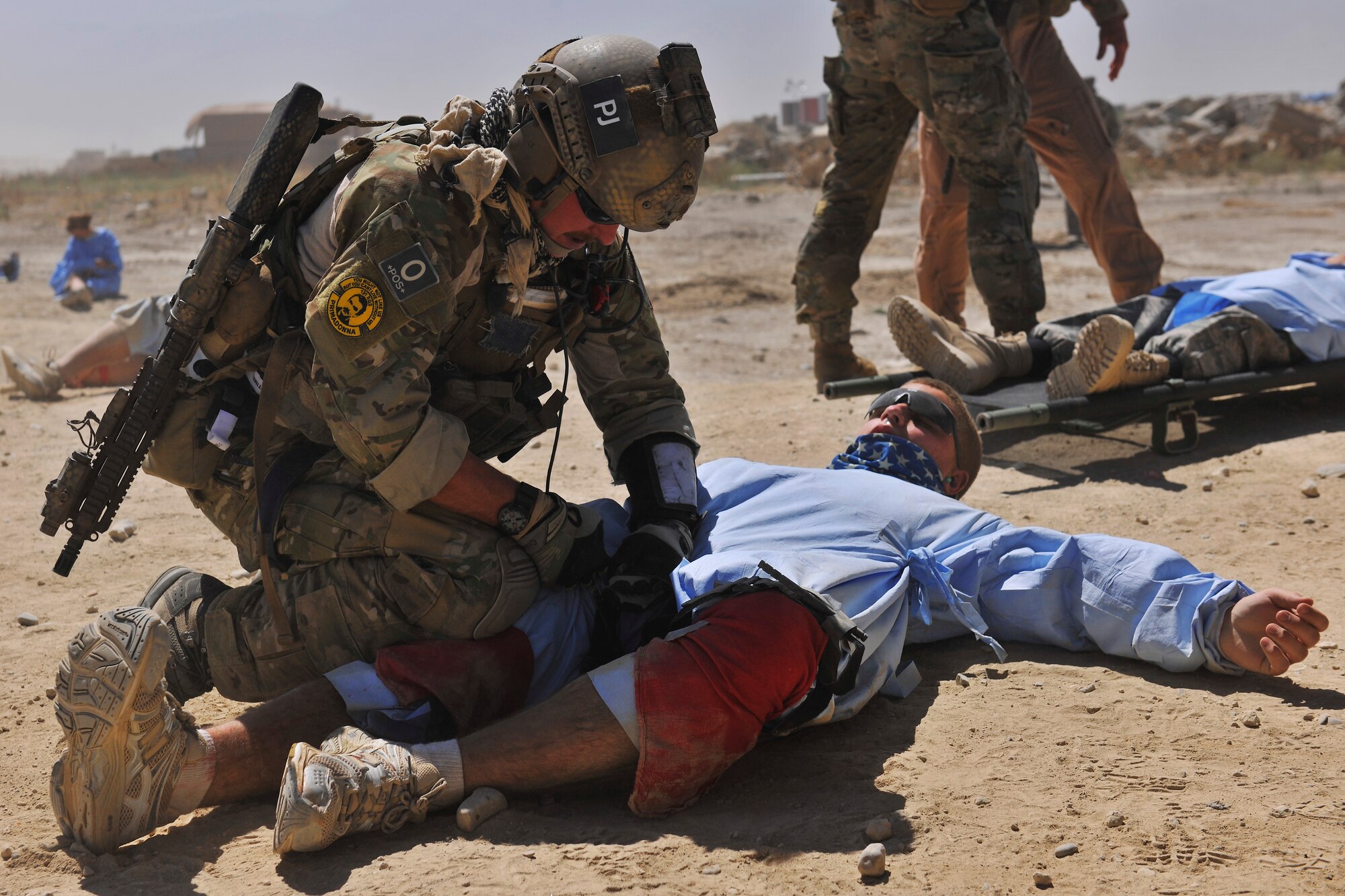 A pararescueman applies a tourniquet to a simulated injured person during an exercise at Bagram Airfield, Afghanistan, Aug. 21. 2010. The exercise tested the rescue squadron?s ability to provide medical aid to U.S. and Coalition forces. (U.S. Air Force photo/Staff Sgt. Christopher Boitz)