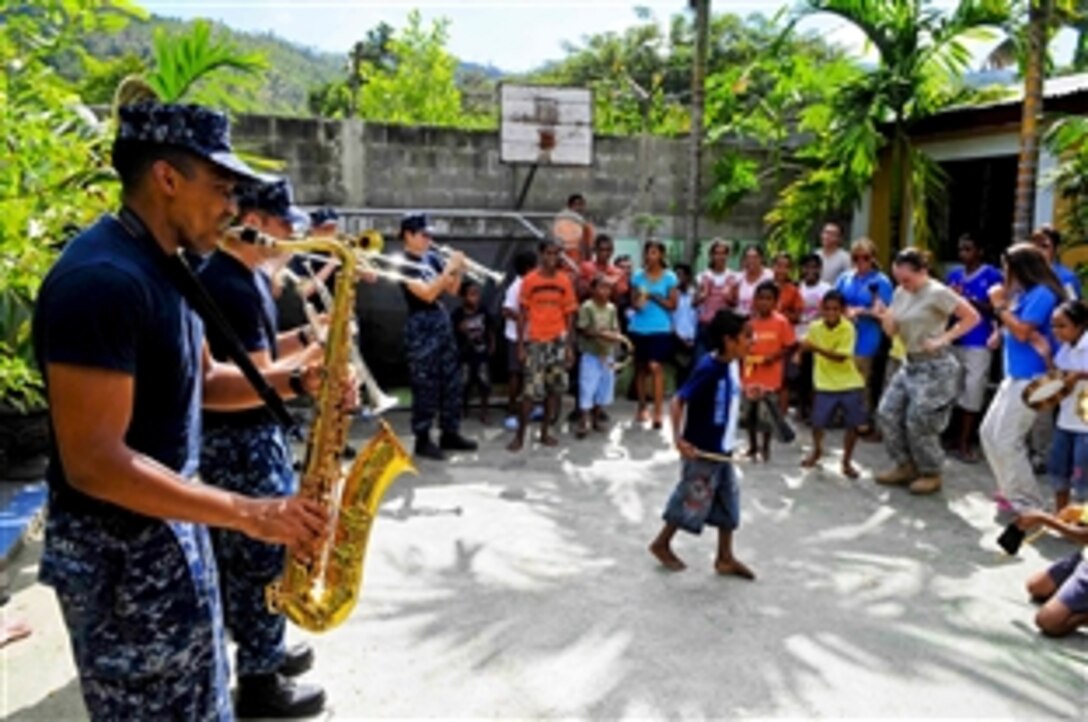 U.S. Navy Petty Officer 2nd Class Jason Gay plays the saxophone during a band performance and community service event as part of Pacific Partnership at the Santa Bakhita Orphanage in Dili, Timor-Leste, Aug. 18, 2010. The partnership program is there to support the fifth in a series of humanitarian assistance and disaster relief endeavors to strengthen regional partnerships.