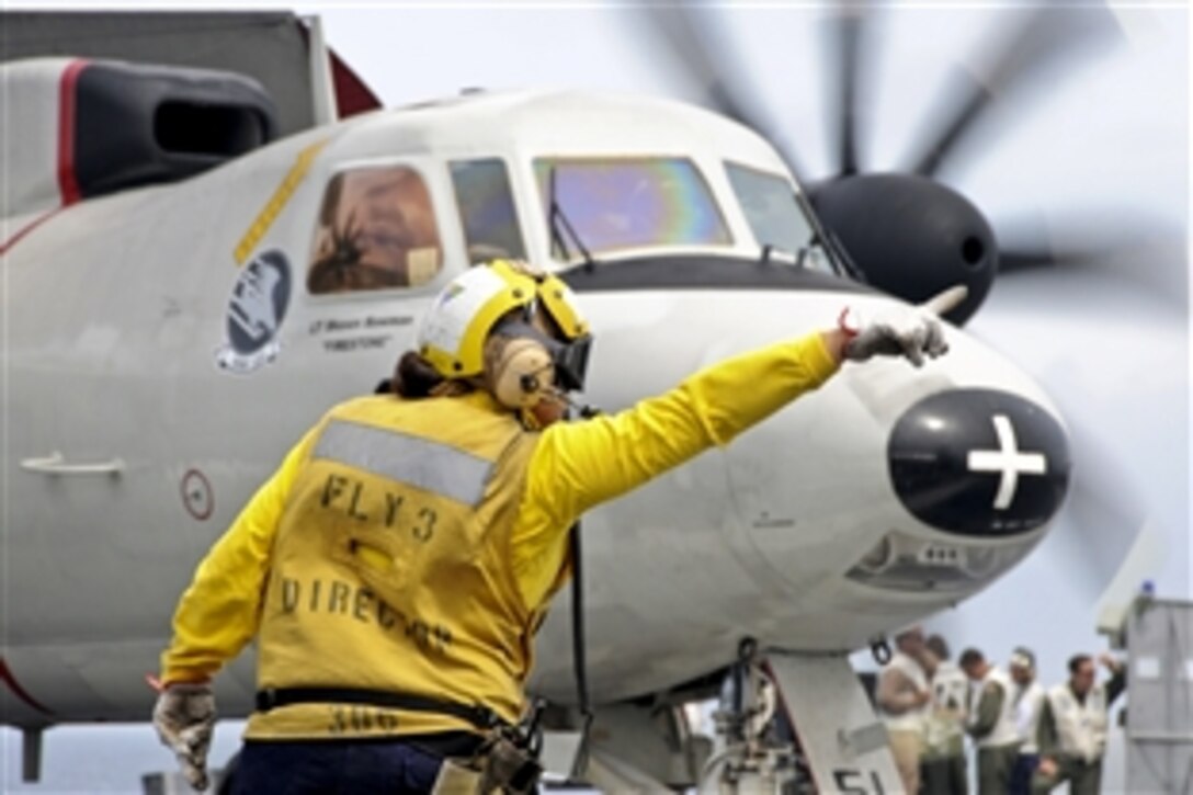 A sailor directs an E-2C Hawkeye aircraft on the flight deck of the USS George H.W. Bush in the Atlantic Ocean, Aug. 22, 2010. The Hawkeye is assigned to the Carrier Airborne Early Warning Squadron 120.