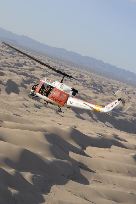 A Headquarters & Headquarters Squadron Search and Rescue HH-1N Huey flies over the Imperial Sand Dunes Recreation Area in California during a routine training flight Aug. 23, 2010. SAR's mission is to support flight operations and rescue missions within 100 nautical miles of the Marine Corps Air Station in Yuma, Ariz.