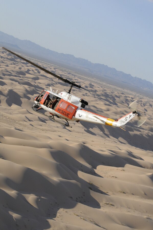 A Headquarters & Headquarters Squadron Search and Rescue HH-1N Huey flies over the Imperial Sand Dunes Recreation Area in California during a routine training flight Aug. 23, 2010. SAR's mission is to support flight operations and rescue missions within 100 nautical miles of the Marine Corps Air Station in Yuma, Ariz.