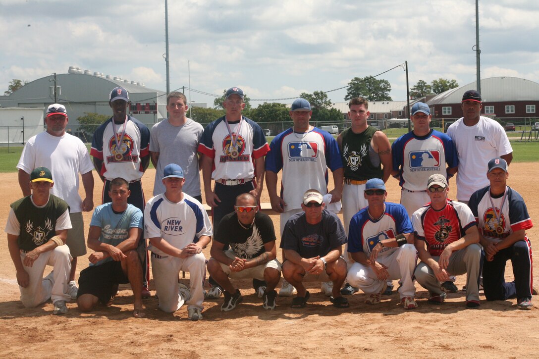 (Far left standing) Dan Daniels, the All-Marine softball team coach, poses with the 15 Marines and Sailors he selected to represent the East Coast during the announcement of the All-Marine softball camp canidates following the East Coast regional tournament Aug. 25. There were three Marines selected from the Quantico team that earned honors as champion of the ECR tournament; four selected from the second place team, New River; a Marine and Sailor from Cherry Point; four from the II Marine Expeditionary Force Camp Lejeune team; and two from the Camp Lejeune Division team.::r::::n::The All-Marine camp started Friday and runs through Sept. 16. Daniels will choose the best 15 out of more than 30 Marines and Sailors who came from Marine installations all around the world to compete in the armed forces softball tournament at Navel Air Station Pensacola, Fla., Sept. 18-24.::r::::n::