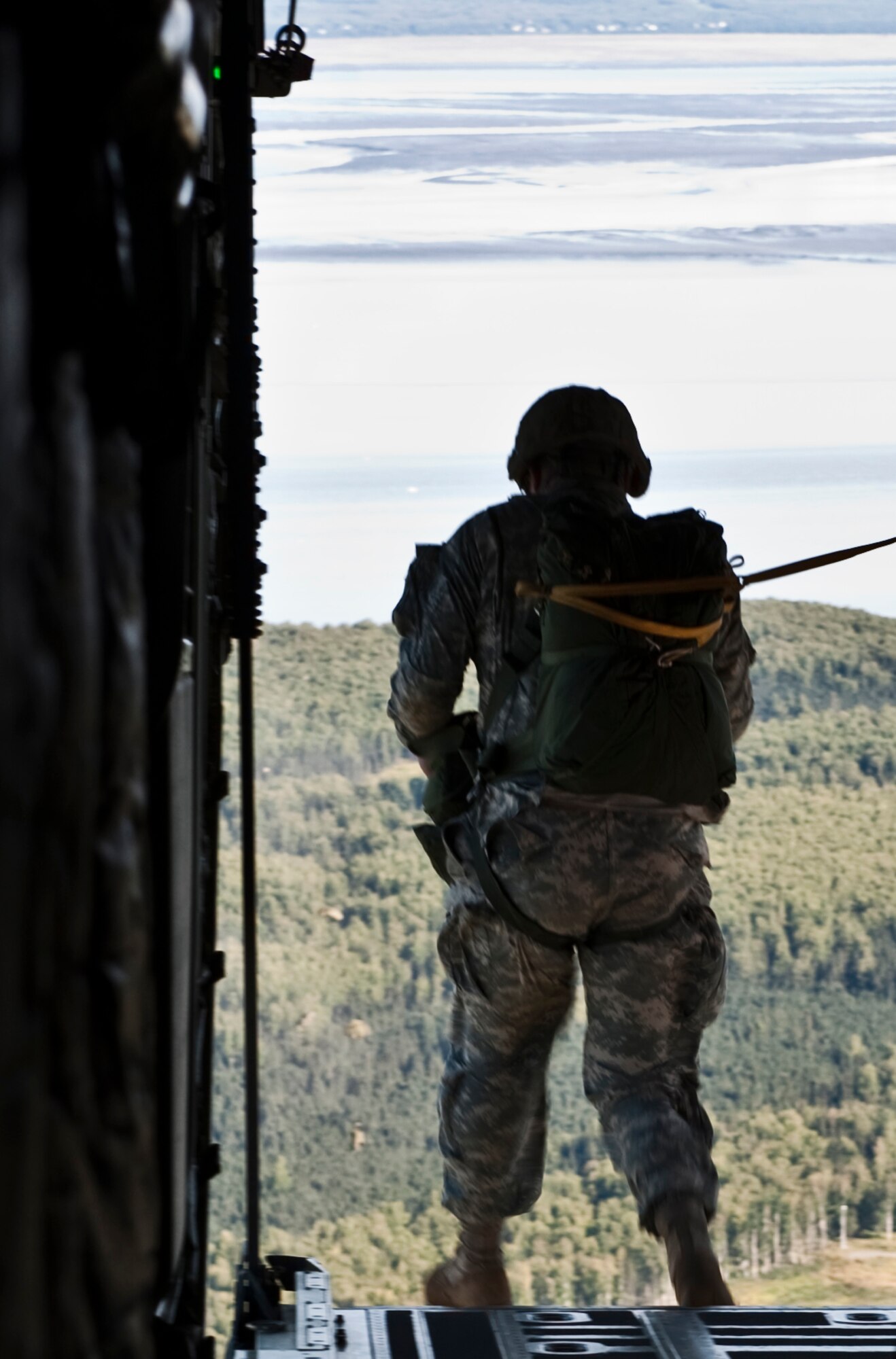 JOINT BASE ELMENDORF-RICHARDSON, Alaska -- A Soldier jumps from the back of a C-130 Hercules Aug. 24. Approximately 50 members from the 425th Brigade Special Troops Battalion participated in a 3-week path finder course at Joint Base Elmendorf-Richardson. Those who participated were looking to become experts in sling load operations, helicopter landing and pickup zone operations along with drop zone operations. (Photo by Airman 1st Class Christopher Gross)