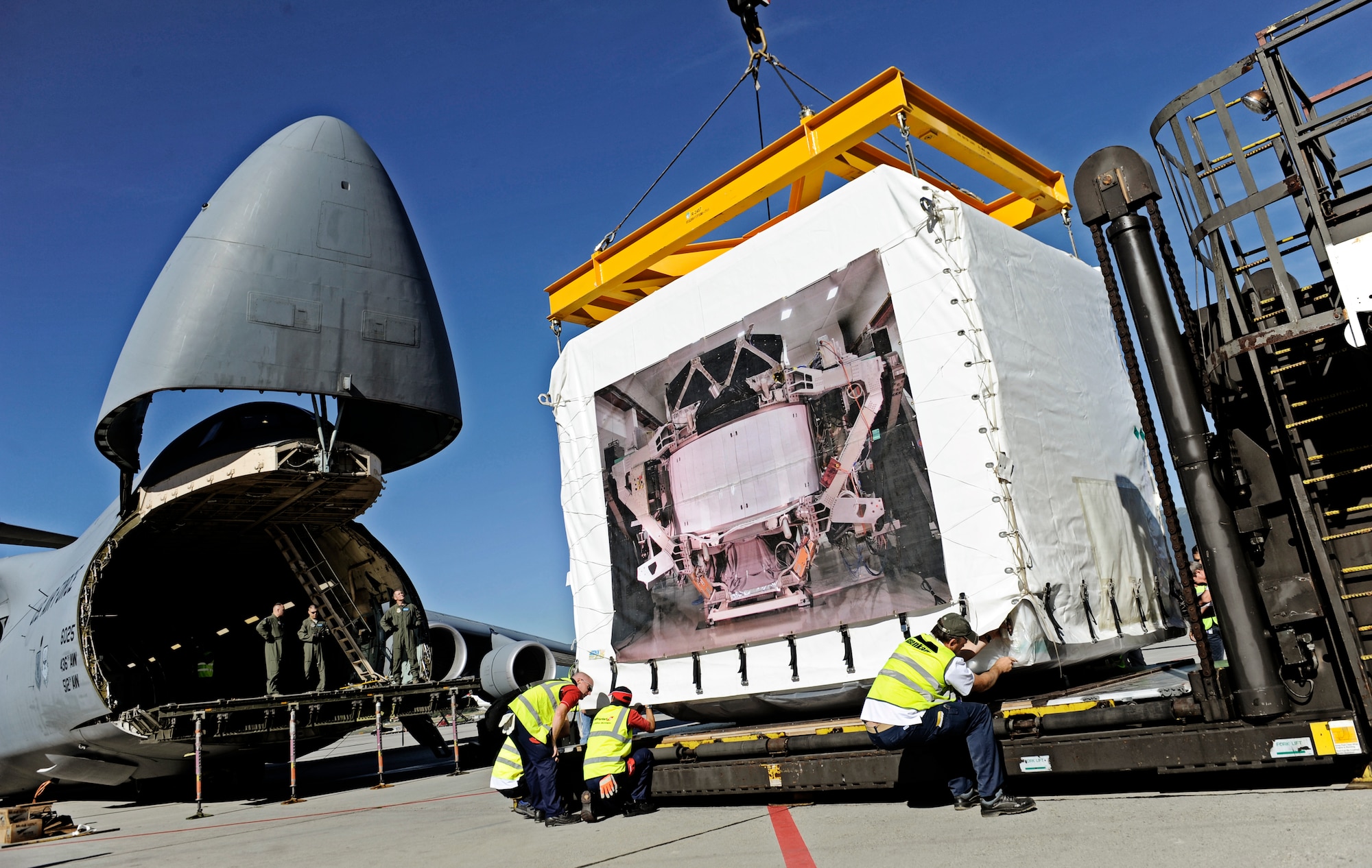 GENEVA, Switzerland -- A C-5M Super Galaxy, based out of Dover AFB, Delaware, is loaded with the Alpha Magnetic Spectrometer at the Geneva, Switzerland airport August 25. The AMS is the brain child of Nobel Laureate, Professor Samuel Ting and has been in production over the last 16 years. The purpose of the experiment is to detect and analyze particles found in space while docked to the International Space Station. According to Prof. Ting, this should help us better understand the universe and how it was created. (U.S. Air Force photo/ Staff Sgt. Ryan Crane)