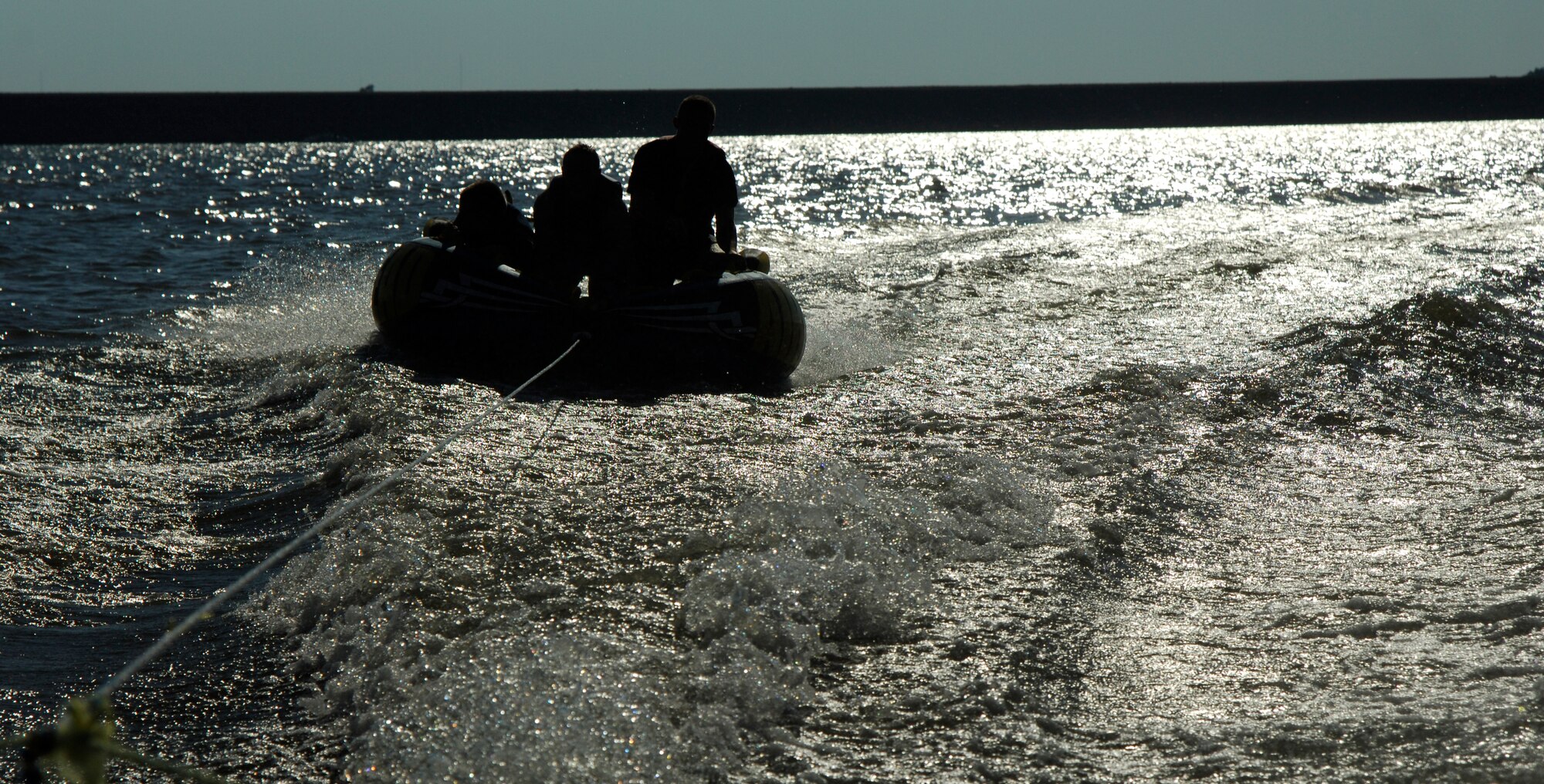 Three Airmen from McConnell Air Force Base ride a tube at El Dorado Lake, Kan. Aug. 21, 2010. The Airmen participated in a Young Adult Retreat hosted by the base chapel. During the retreat, the Airmen shared experiences designed to promote spiritual and social fitness. (U.S. Air Force photo/Airman 1st Class Armando A. Schwier-Morales)