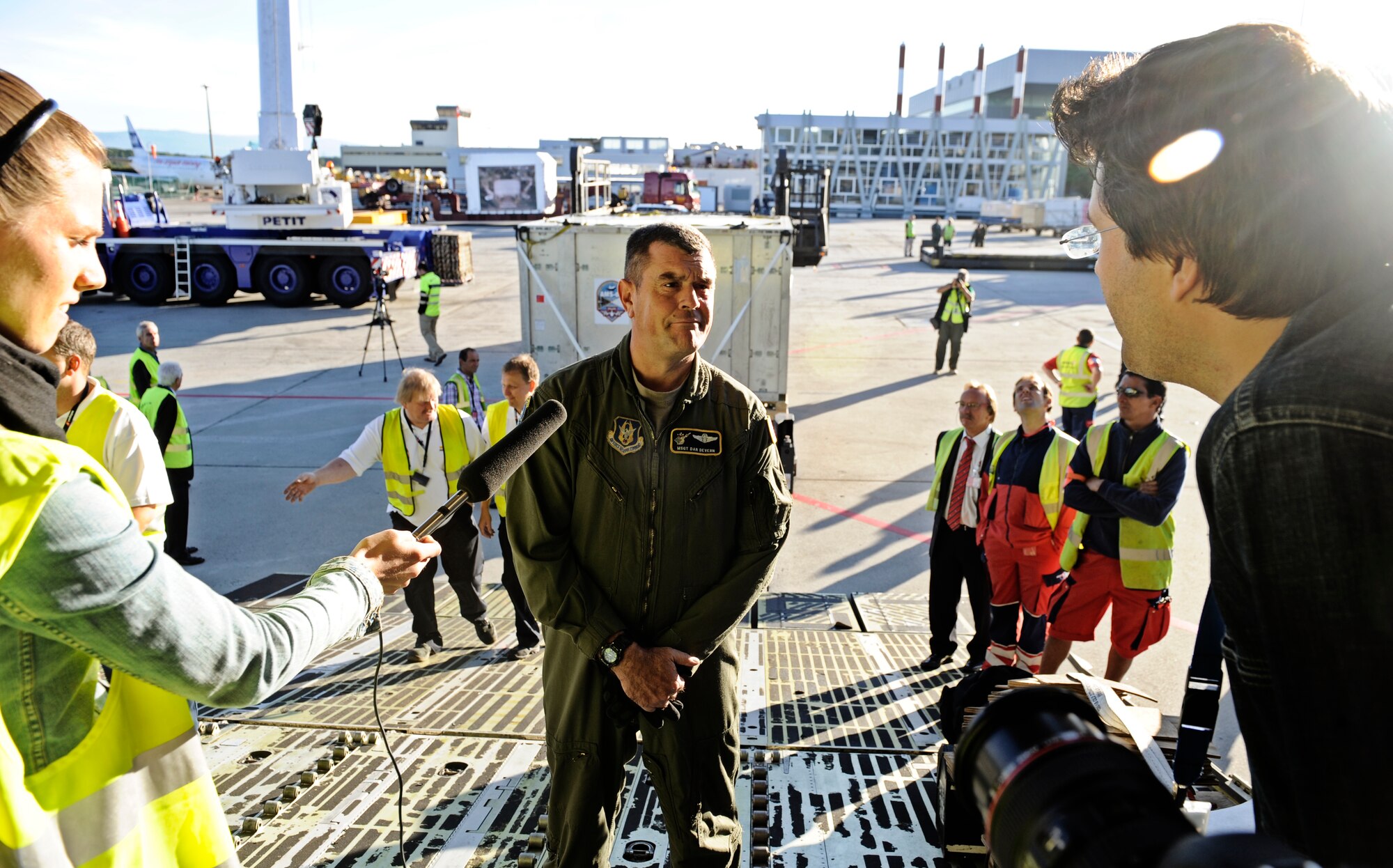 GENEVA, Switzerland -- Master Sgt. Dan Devern, 9th Airlift Squadron, speaks to local news agencies about the Air Force's role in the Alpha Magnetic Spectrometer mission August 25 in Geneva, Switzerland. The AMS is the brain child of Nobel Laureate, Professor Samuel Ting and has been in production over the last 16 years. The purpose of the experiment is to detect and analyze particles found in space while docked to the International Space Station. According to Prof. Ting, this should help us better understand the universe and how it was created. (U.S. Air Force photo/ Staff Sgt. Ryan Crane)