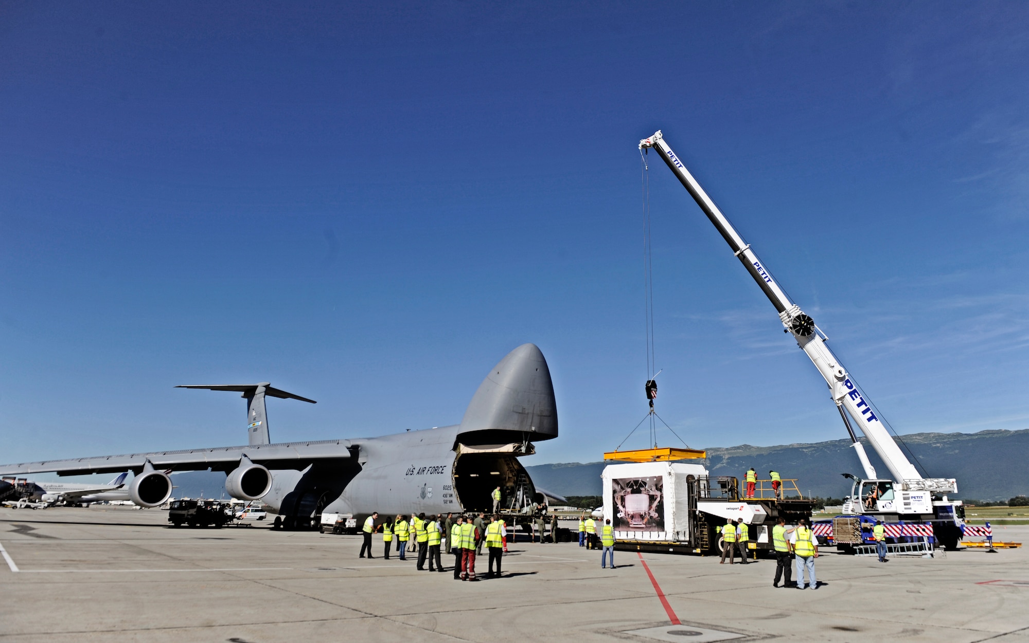 GENEVA, Switzerland -- A C-5M Super Galaxy, based out of Dover AFB, Delaware, is loaded with the Alpha Magnetic Spectrometer at the Geneva, Switzerland airport August 25. The AMS is the brain child of Nobel Laureate, Professor Samuel Ting and has been in production over the last 16 years. The purpose of the experiment is to detect and analyze particles found in space while docked to the International Space Station. According to Prof. Ting, this should help us better understand the universe and how it was created. (U.S. Air Force photo/ Staff Sgt. Ryan Crane)