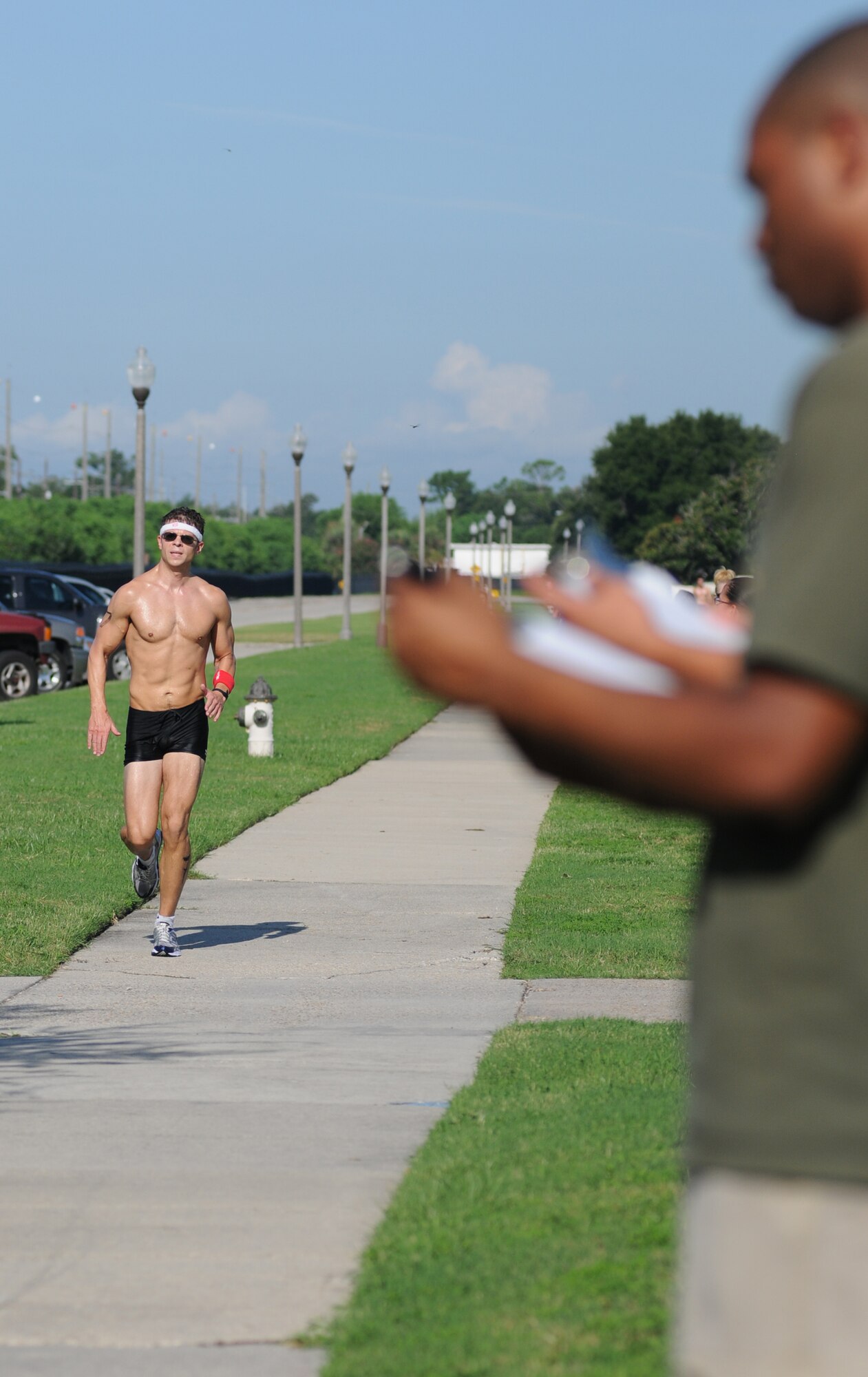 David Frank, 81st Dental Squadron, is timed during his 2-mile run by volunteer LaDarrius Drinkard, 81st Aerospace Medicine Squadron.  Frank placed first in the Clydesdale Division for men 200 pounds and more with an overall time of 40:23.  (U.S. Air Force photo by Kemberly Groue)