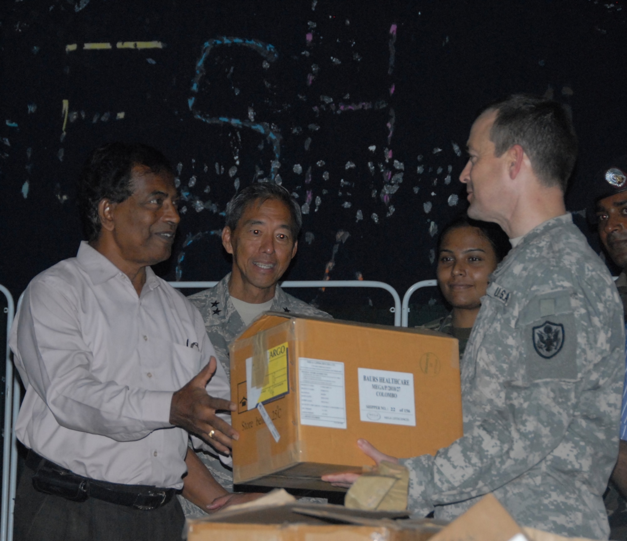 U.S. military servicemembers participating in Operation Pacific Angel-Sri Lanka present Sri Lankan medical officials with donated medical supplies at the conclusion of the Pacific Angel mission on Aug. 21, 2010.  More than 40 representatives from the U.S. Air Force, U.S. Army, U.S. Navy, and the U.S. Marines, as well as American public health service practitioners participated in the humanitarian effort.  Pacific Angel is a humanitarian and civic assistance program aimed at improving military civic cooperation between the United States and countries throughout the Asia-Pacific region. (U.S. Air Force photo/ Master Sgt. Mike Hammond) 

