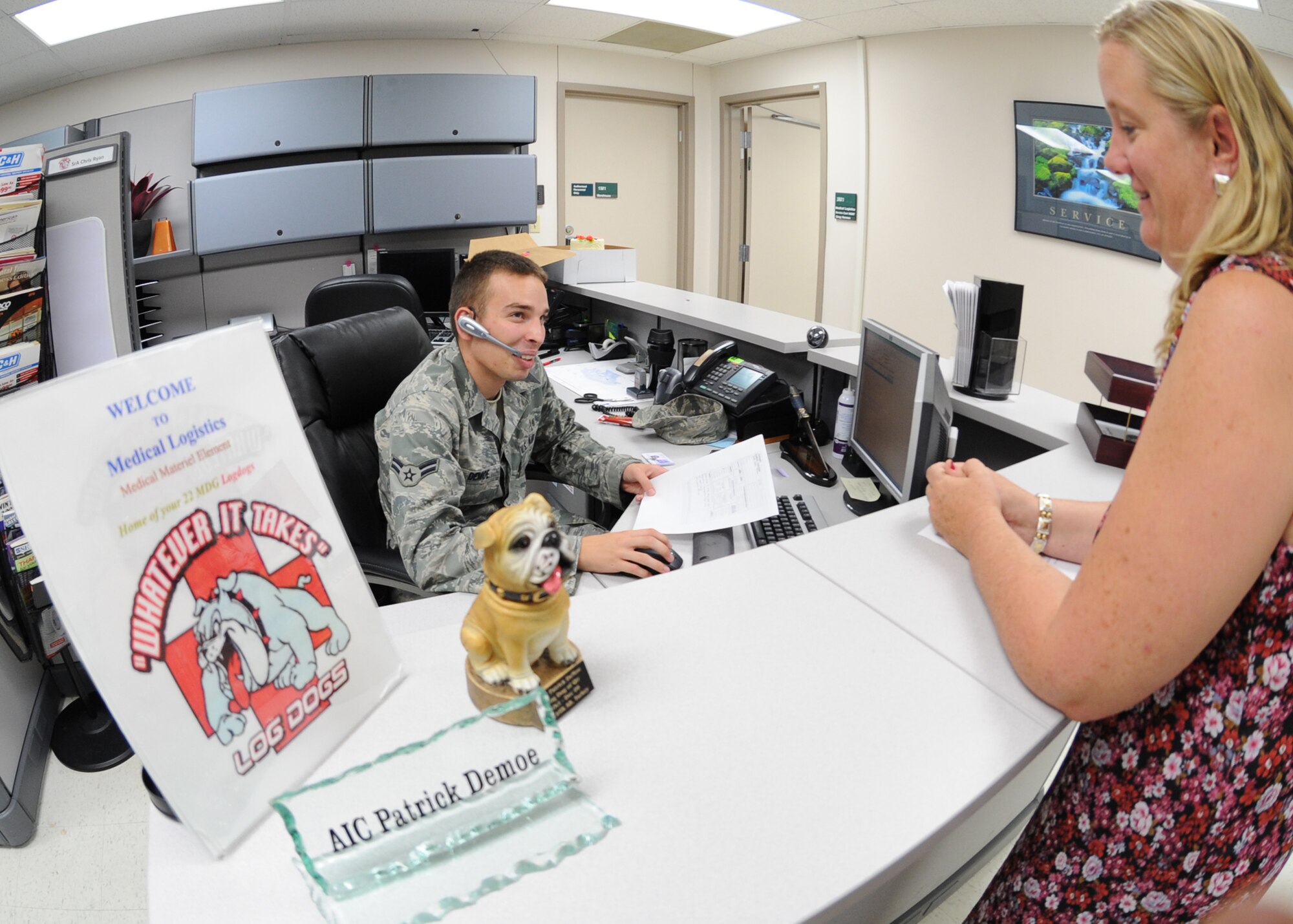 Airman 1st Class Patrick Demoe, 22nd Medical Support Squadron customer service representative, receives paperwork from Tresa Friesen, 22nd MDSS budgeting analyst, for purchasing medical equipment and supplies Aug. 20, 2010, McConnell Air Force Base, Kan.  The 22nd Medical Logistics Flight orders and maintains medical supplies for the 21,000 beneficiaries that use the base clinic.  The flight also provides deploying Airmen with anthrax and small pox vaccinations as part of their deployment kits.  (U.S. Air Force photo/Airman 1st Class Andrea Salazar)