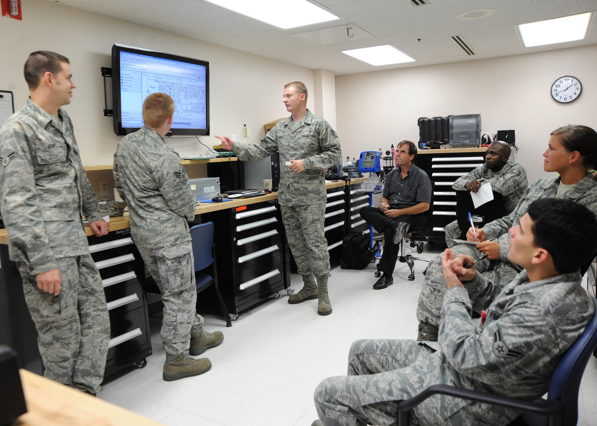Staff Sgt. Jimmy Sifrit, Airman 1st Class Connor Galvin and Airman 1st Class Lawrence Seay, 22nd Medical Support Squadron biomedical equipment technicians, explain the radio-frequency identification system to Airmen of the medical logistics flight Aug. 20, 2010, McConnell Air Force Base, Kan.  The RFID is a wireless tracking system used to find the real-time location, or past location of any medical equipment.  McConnell’s clinic is the first Air Force clinic to implement its own $100K RFID system, and is currently tracking more than 1,200 pieces of medical equipment.  (U.S. Air Force photo/Airman 1st Class Andrea Salazar)