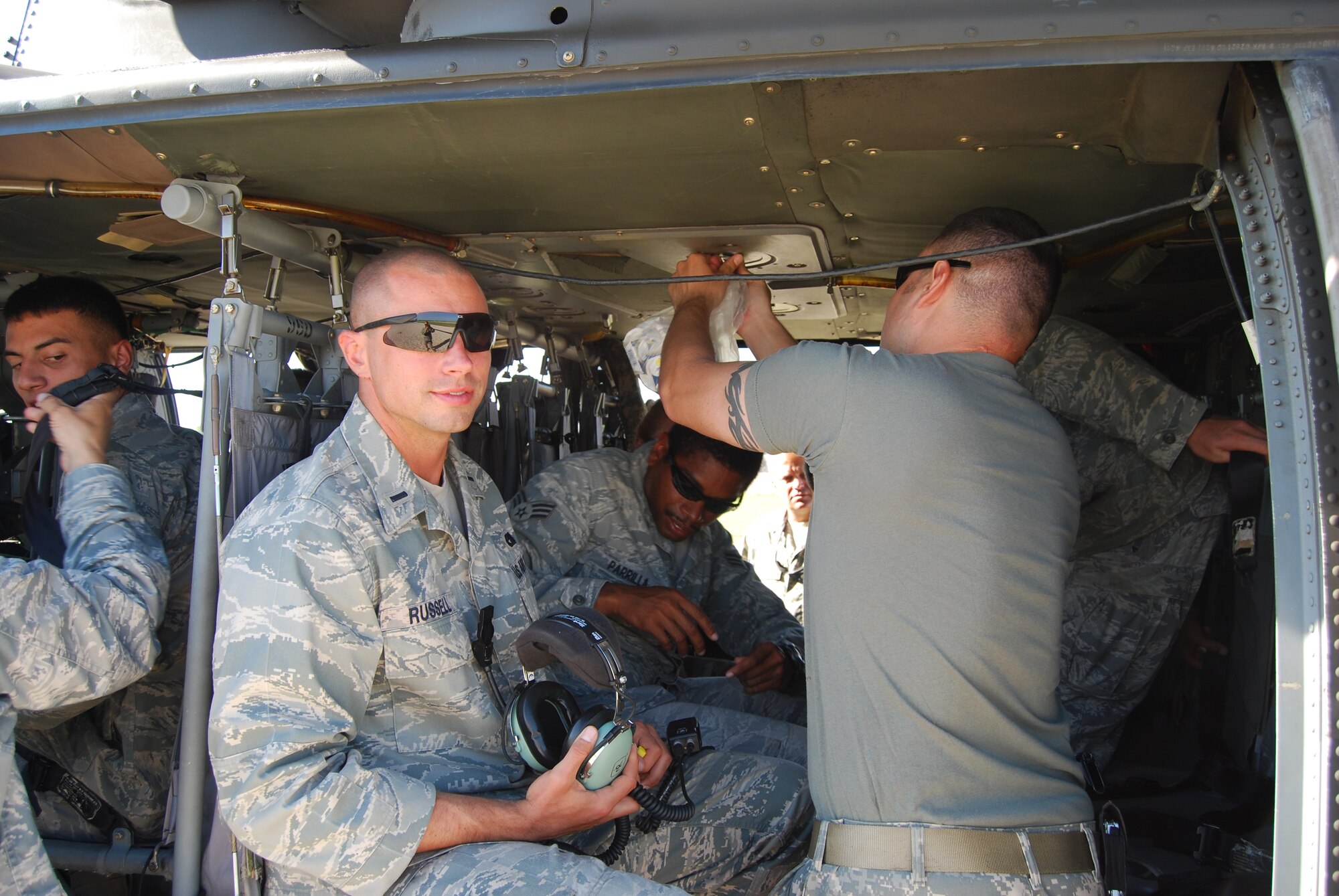 SCOTT AIR FORCE BASE, Ill. -- First Lt. Christopher Russell straps into a UH-60 Blackhawk helicopter to get an aerial view of the tent cities surrounding Port-au-Prince, Haiti. The lieutenant, from the 375th Logistics Readiness Squadron, was deployed to Haiti from February to June. (courtesy photo)