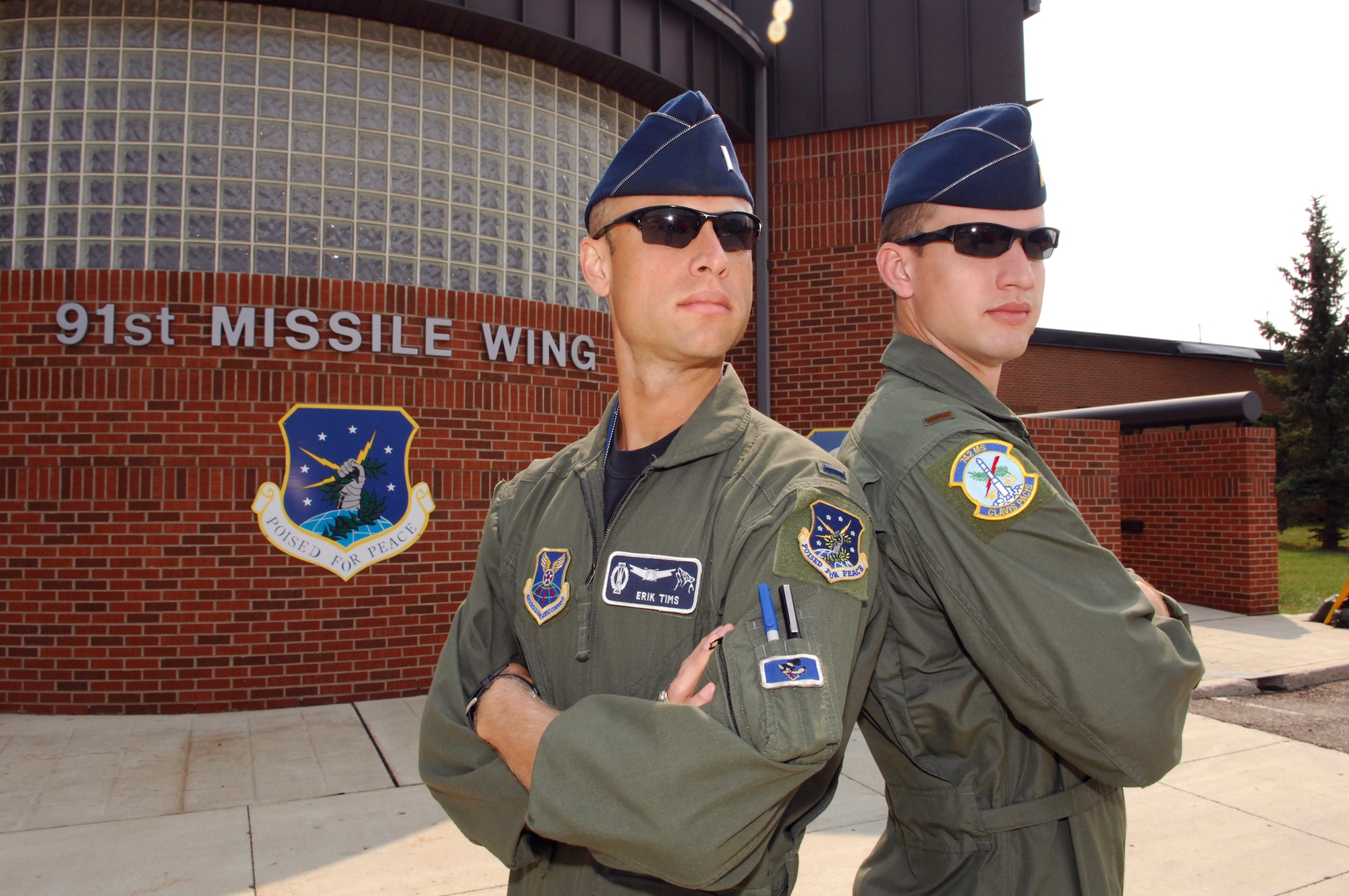 1st Lt. Erik Tims and 2nd Lt. Patrick Tims pose for a photo outside of the 91st Missile Wing headquarters building Aug. 18. The two lieutenants, who happen to be brothers, took part in a once-in-a-lifetime event at Minot AFB here by pulling their first and last alert together Aug. 19, 2010 at Minot AFB. N.D. Erik and Patrick are both with the 742nd Missile Squadron here. (U.S. Air Force photo/Tech. Sgt. Thomas Dow)