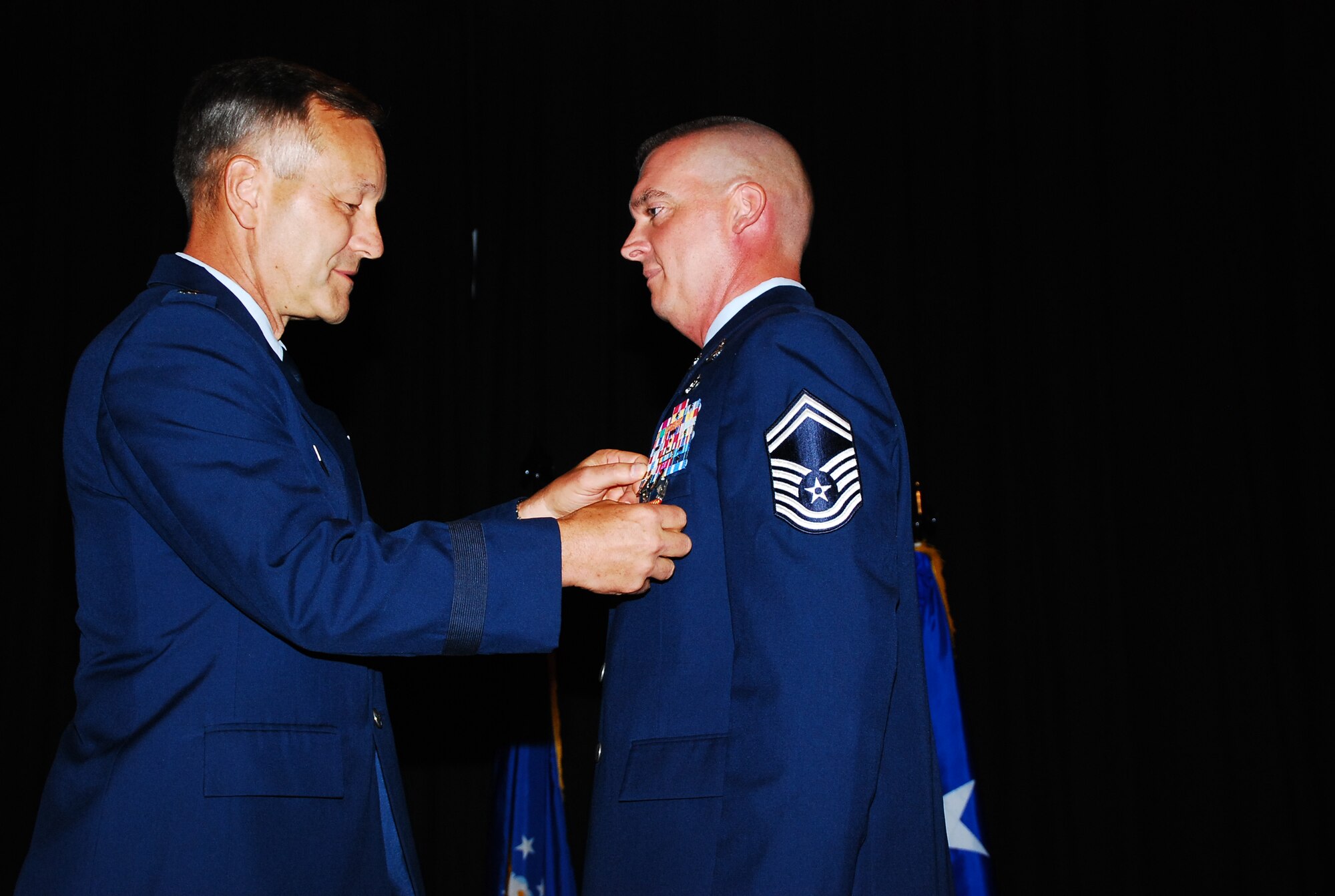 SCOTT AIR FORCE BASE, Ill. -- Maj. Gen. Eric Crabtree, Fourth Air Force commander, presents Senior Master Sgt. Ryan Nichols with the Bronze Star, the Air Force Combat Action Medal and the Navy and Marine Corps Achievement Medal for his service in Afghanistan.  Sergeant Nichols is a member of the 932nd Airlift Wing’s Explosive Ordnance Disposal unit at Scott Air Force Base.  (U.S. Air Force photo/Tech. Sgt. Dan Oliver)