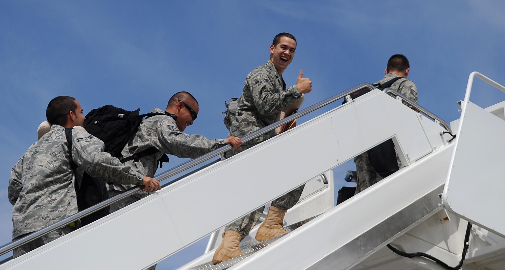 SEYMOUR JOHNSON AIR FORCE BASE, N.C. – An Airman the 4th Fighter Wing takes one last look at the flightline and gives a thumbs up as he boards an aircraft enroute to support Operation Enduring Freedom Aug. 22, 2010. These Airmen are support personnel, maintainers, pilots, and weapons system officers deploying to execute a close air support mission from Bagram Airfield, Afghanistan. (U.S. Air 
Force photo/Senior Airman Makenzie Lang)
