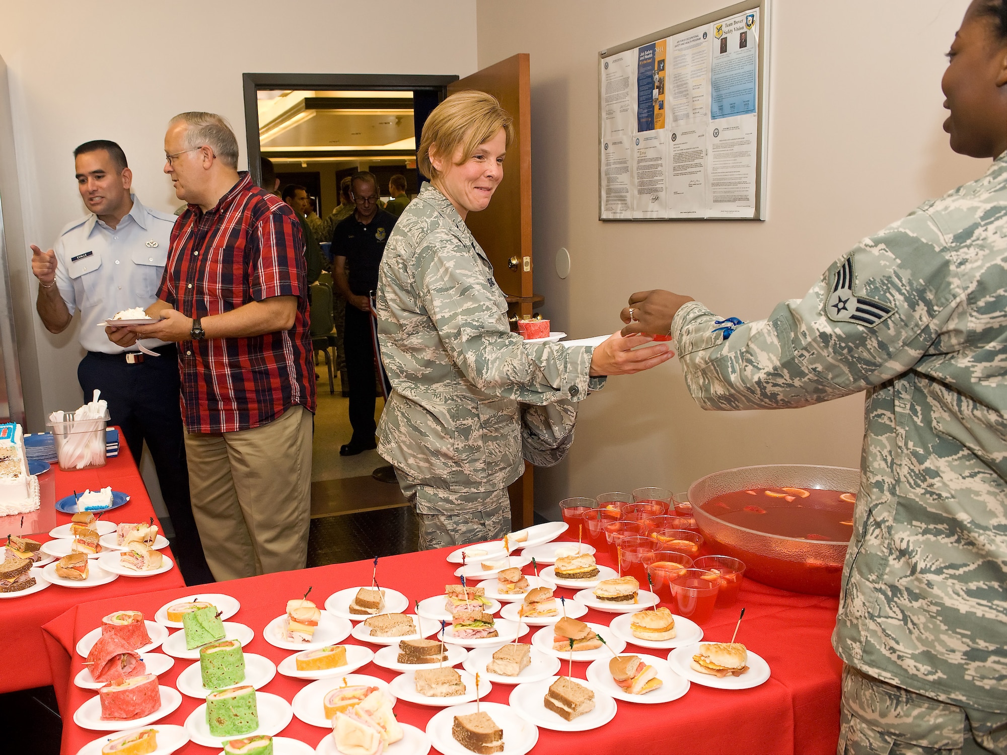 Guests enjoy freshly prepared refreshments at the flight kitchen ribbon cutting ceremony Aug. 20, 2010. The flight kitchen was moved from the dining facility to the passenger terminal to eliminate missed passenger meals. (U.S. Air Force photo by Roland Balik/Released)