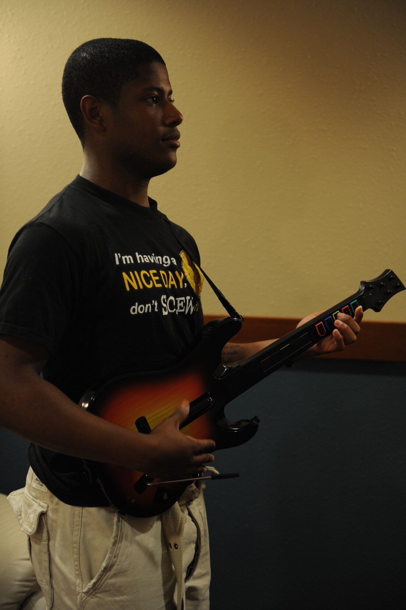 SCOTT AIR FORCE BASE, Ill. -- Airman 1st Class Marvin Reese III, 375th Logistics Readiness Squadron vehicle management and analysis apprentice plays Guitar Hero during the Guitar Hero tournament. He placed first giving the Shiloh dorms first place points. (U.S. Air Force photo/Senior Airman Tristin English)
