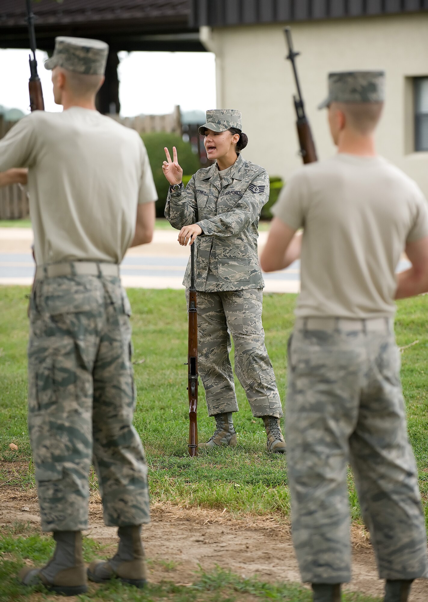 Staff Sgt. Krystie Anderson, U.S. Air Force Honor Guard, instructs Team Dover members on proper use of ceremonial rifles during training at the Base Honor Guard on Dover Air Force Base, Del., Aug. 13, 2010. Instructors from the U.S. Air Force Honor Guard visited to train Team Dover members on Honor Guard duties. (U.S. Air Force photo by Jason Minto/Released)