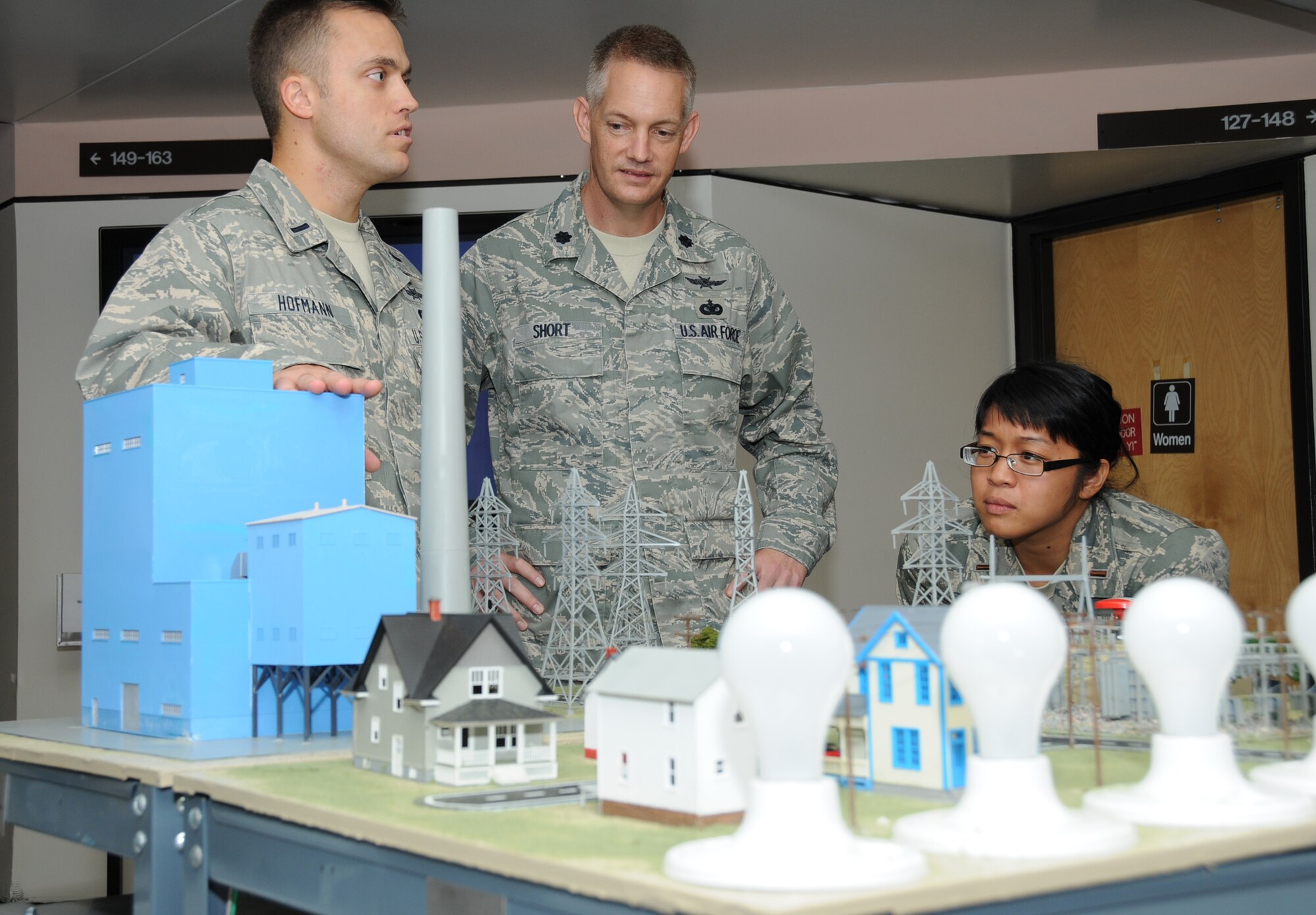 First Lt. Walker Hofmann, a undergraduate cyber training course instructor in the 333rd Training Squadron, shows a training mockup to his new commander, Lt. Col. Douglas Short, and one of his students, 2nd Lt. Hannah Marcelo, Aug. 19.  Colonel Short, who took command July 30, previously served with U.S. Joint Forces Command, Naval Station Norfolk, Va., where he was executive officer for the command, control, communications and computer directorate.  Lt. Col. Scott Solomon, who had led the 333rd TRS for two years, is now the deputy commander of the 81st Training Group.  (U.S. Air Force photo by Kemberly Groue)