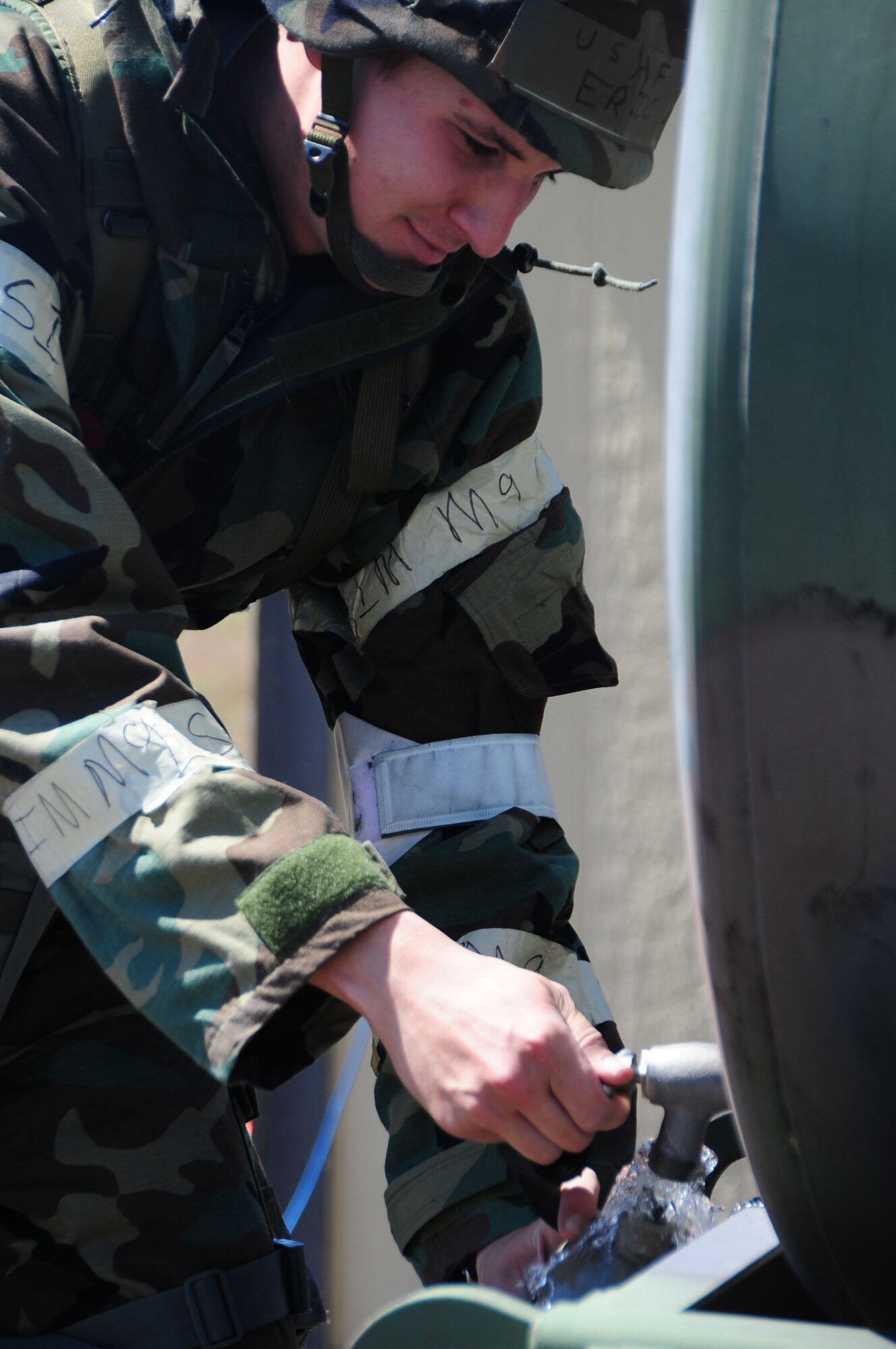 ELLSWORTH AIR FORCE BASE, S.D. -- Airman 1st Class Eric Judd, 28th Medical Operations Squadron medical technician, fills up his canteen during a phase II operational readiness exercise, Aug. 24.  Staying hydrated is essential to avoiding heat stoke and dehydration. (U.S. Air Force photo/Airman 1st Class Anthony Sanchelli)