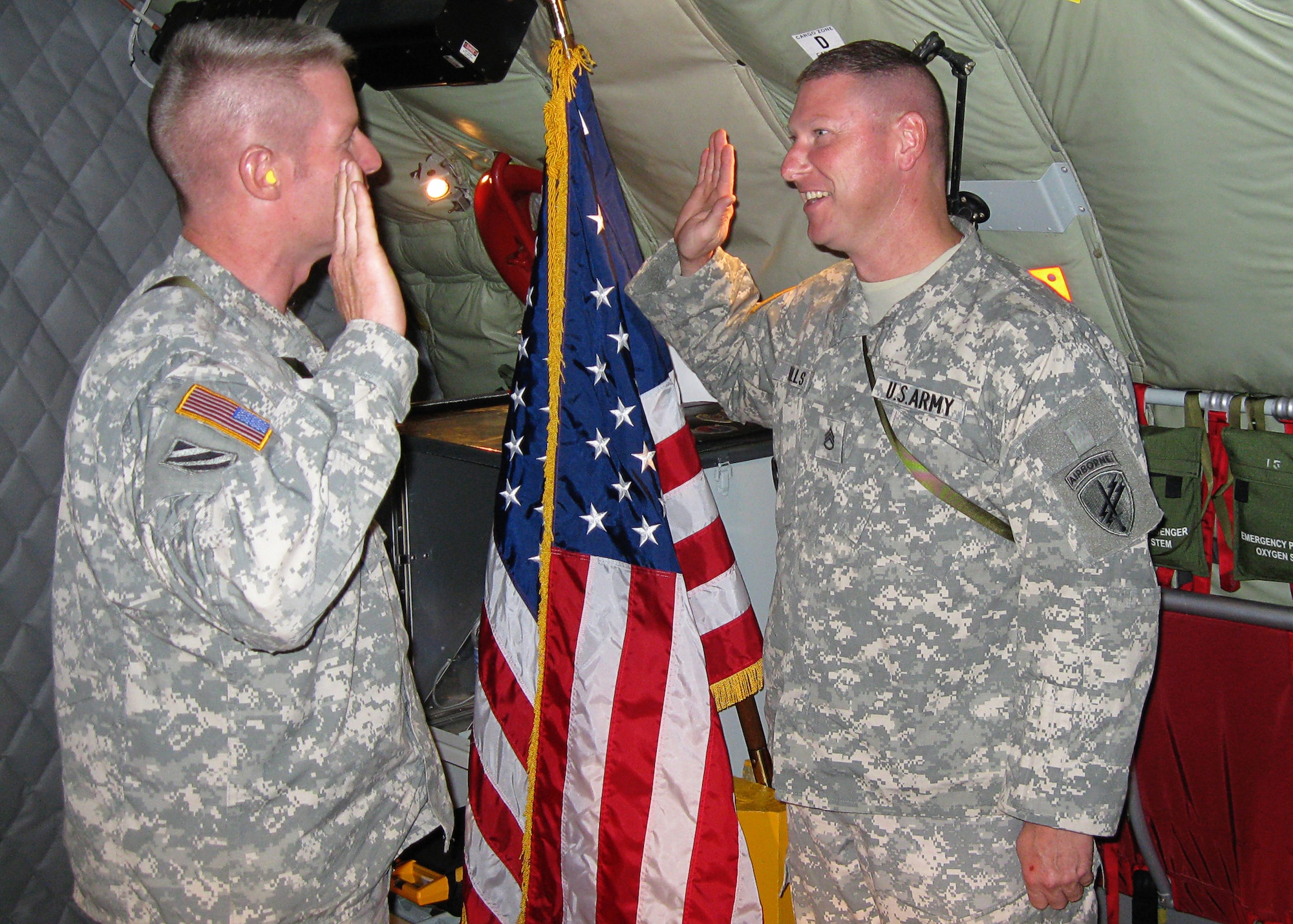 GRISSOM AIR RESERVE BASE, Ind. -- Army Reserve Maj. Scott Thomson administers the oath of enlistment to Staff Sgt. John Walls, a psychological operations specialist with the 316th Psychological Operations Company, as he reenlists Aug. 20 onboard a KC-135R Stratotanker from the Air Force Reserve's 434th Air Refueling Wing. The 316th PSYOP is an Army Reserve unit located on Grissom Air Reserve Base, Ind., and Major Thomson is the unit's commander. (U.S. Air Force photo/Tech. Sgt. Mark R. W. Orders-Woempner)     