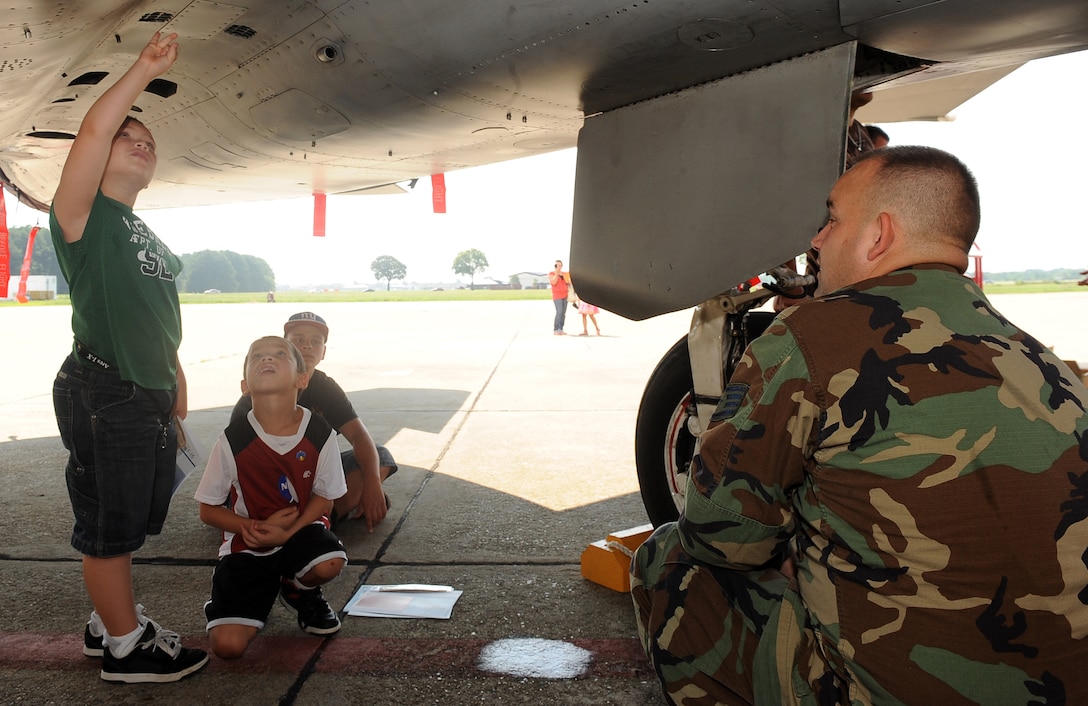 LANGLEY AIR FORCE BASE, Va. - Staff Sgt. Christopher Kinter, 71st Fighter
Squadron crew chief, shows an F-15 to Michael, Carlos and Tomas Greene during National Aeronautics and Space Administration "Bring Your children to
Work Day" Aug. 20. NASA hosted the event to allow children of employees to observe their parents at work, as well as view an F-15 Eagle. (U.S. Air
Force photo/Senior Airman Gul Crockett)