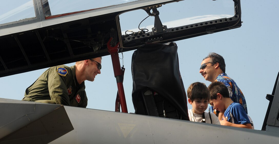 LANGLEY AIR FORCE BASE, Va. - Capt. Brent Tittle, 71st Fighter Squadron pilot, shows an F-15 to Noah Dunn during "Bring Your Children to Work Day"
Aug. 20. National Aeronautics and Space Administration hosted the event to allow children of employees to observe their parents at work, as well as view an F-15 Eagle. (U.S. Air Force photo/Senior Airman Gul Crockett)
