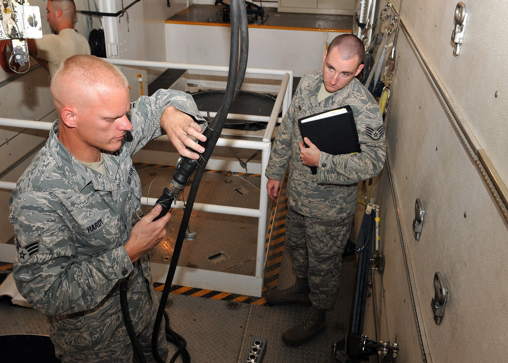 MINOT AIR FORCE BASE, N.D. -- Senior Airman James Hardy, 91st Missile Maintenance Squadron missile maintenance team technician, makes equipment checks on his team’s vehicle prior to departure while Staff Sgt. Jason Keen, 91st Maintenance Group quality assurance evaluator, watches here Aug. 18. Vehicle inspections like these are administered by a two-man team to ensure the safety of both Airmen and Air Force assets while in movement through the missile field.  (U.S. Air Force photo by Senior Airman Michael J. Veloz)