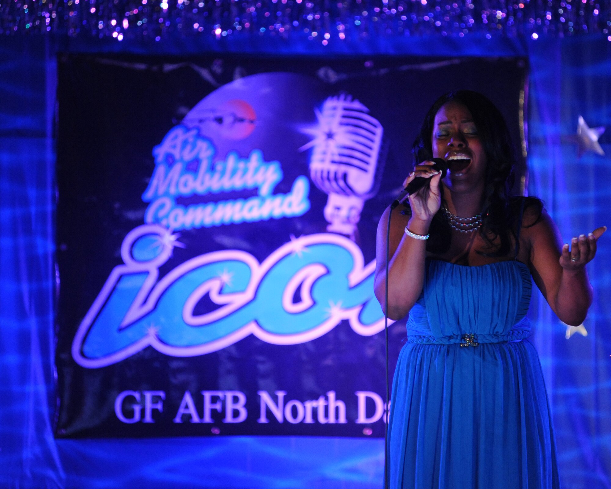 Airman 1st Class Tiemoeshea M. King, 319th Medical Support Squadron, sings “I Will Always Love You” by Whitney Houston during the Air Mobility Command ICON contest Aug. 19 at the Northern Lights Club on Grand Forks Air Force Base, N.D. Airman King won the contest and earned a chance to compete at Scott AFB, Ill. If Airman King wins the contest at Scott AFB, she will have an opportunity to perform with Tops In Blue. (U.S. Air Force photo by Tech. Sgt. Johnny L. Saldivar)