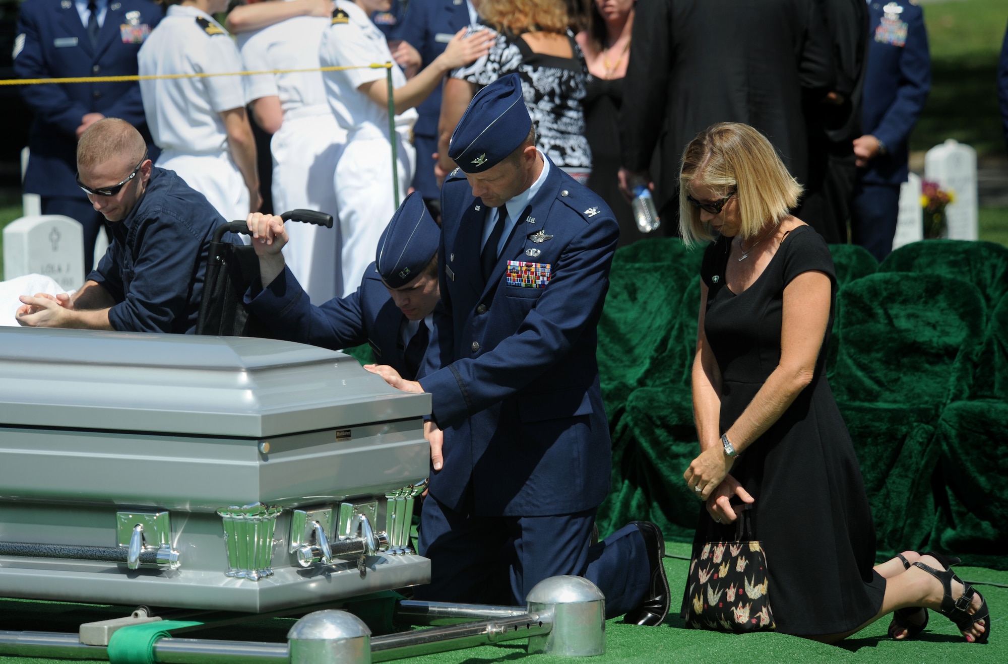ARLINGTON, Va. -- Col. Gary Henderson, 23rd Wing commander, his wife Erin and Capt. Kyle Deem, 41st Rescue Squadron pilot, pay their respects to Capt. David A. Wisniewski during his interment at Arlington National Cemetery Aug. 23. Captain Wisniewski was out of the 66th Rescue Squadron, Nellis Air Force Base, Nev., which is a geographically-separated unit of the 23rd Wing. (U.S. Air Force photo/Staff Sgt. Gina Chiaverotti-Paige)