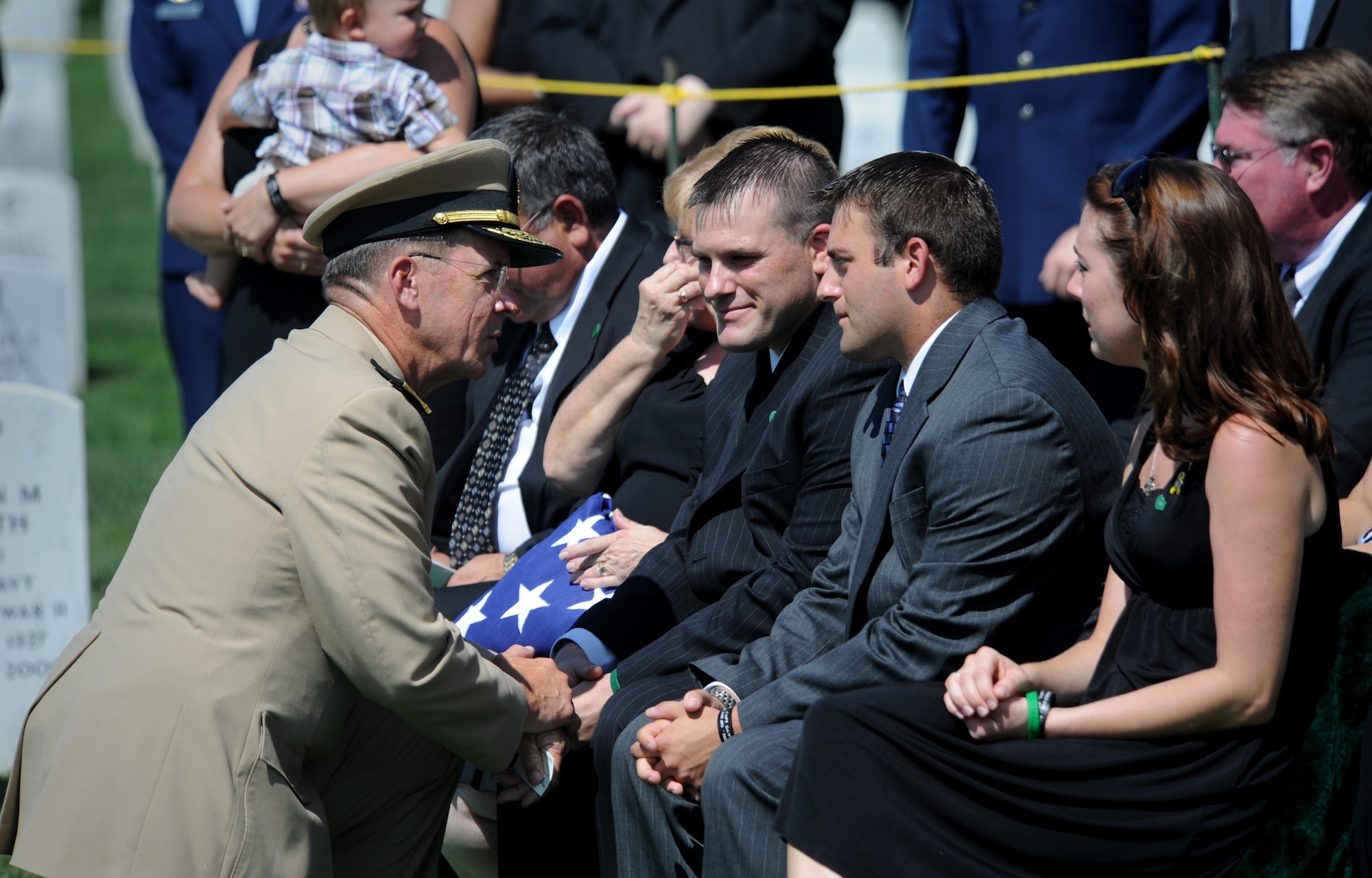 ARLINGTON, Va. -- Navy Adm. Mike Mullen, Chairman of the Joint Chiefs of Staff, gives his condolences to Craig and Matt Wisniewski, brothers of Capt. David A. Wisniewski, during his interment at Arlington National Cemetery Aug. 23. (U.S. Air Force photo/Staff Sgt. Gina Chiaverotti-Paige)
