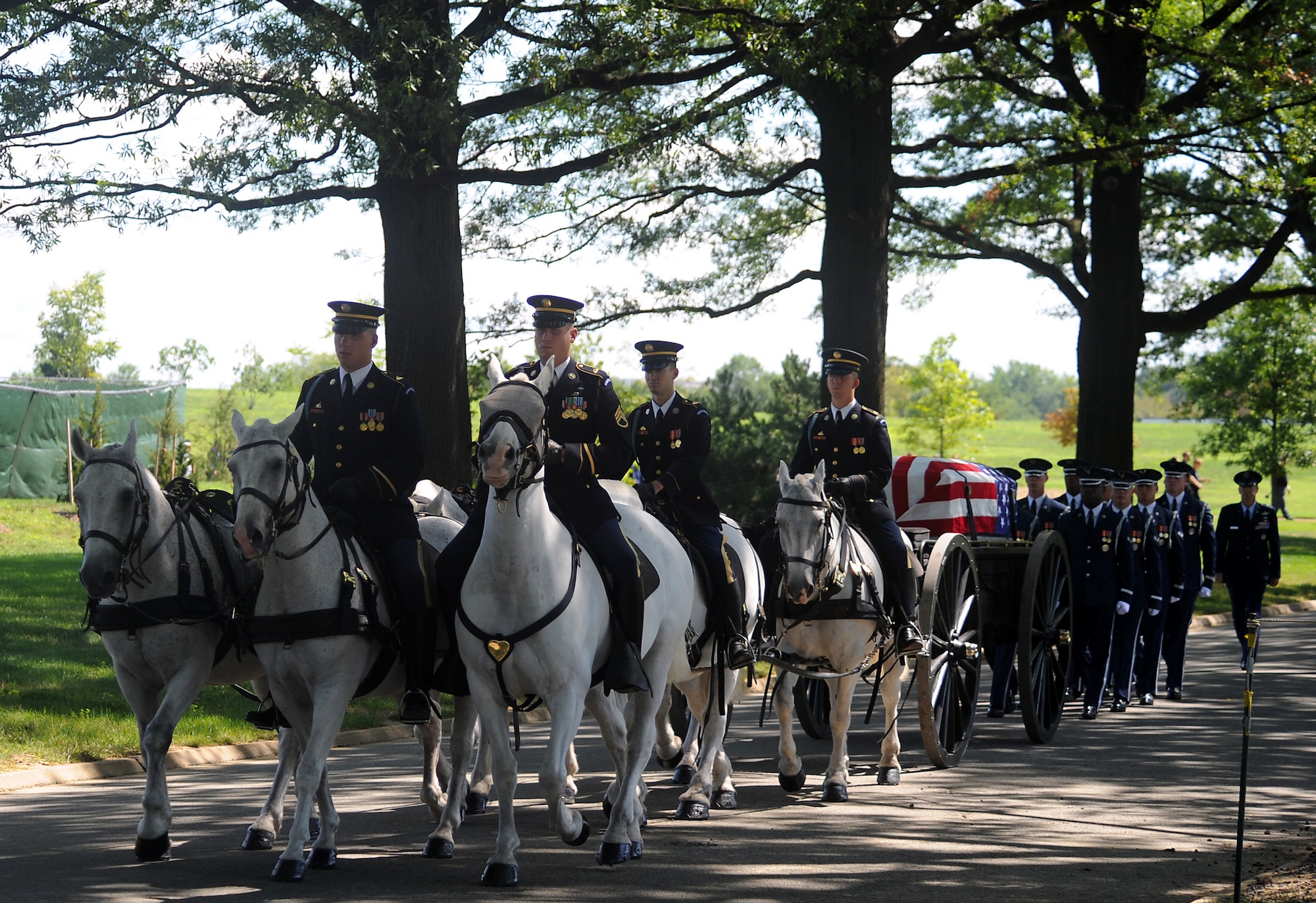 ARLINGTON, Va. -- The 3rd U.S. Infantry, traditionally known as "The Old Guard," carrying Capt. David A. Wisniewski is followed by the U.S. Air Force Honor Guard during an interment at Arlington National Cemetery Aug. 23. (U.S. Air Force photo/Staff Sgt. Gina Chiaverotti-Paige) 