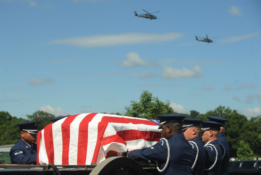 ARLINGTON, Va. -- U.S. Air Force Honor Guard Ceremonial Guardsmen transfer Capt. David A. Wisniewski on to a caisson while HH-60G Pave Hawks fly over during his interment at Arlington National Cemetery Aug. 23. Captain Wisniewski died July 2, 2010, from injuries suffered during a helicopter crash in Afghanistan. He was out of the 66th Rescue Squadron, Nellis Air Force Base, Nev., which is a geographically-separated unit of the 23rd Wing. (U.S. Air Force photo/Staff Sgt. Gina Chiaverotti-Paige)