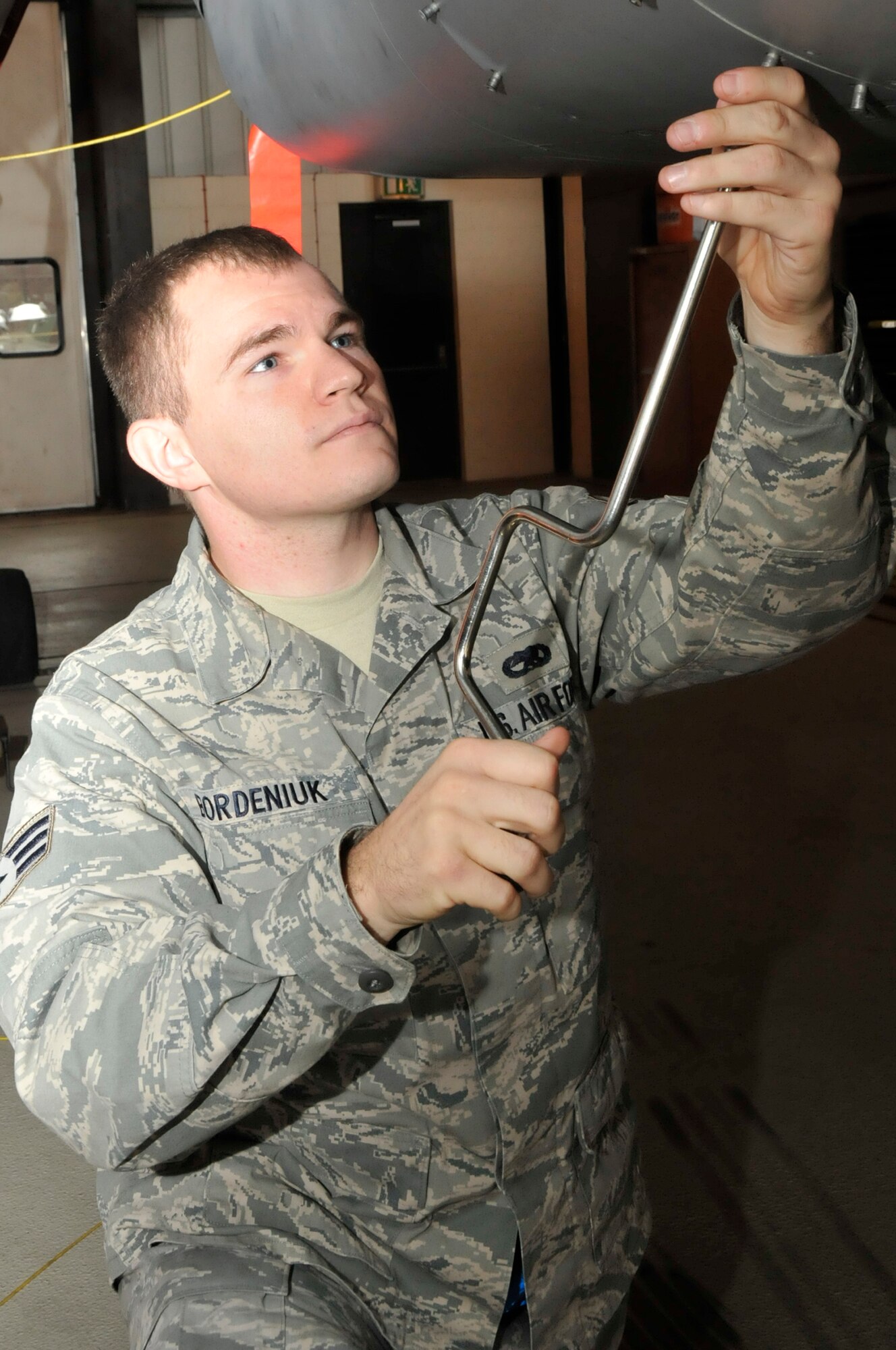 Senior Airman Michael Bordeniuk, 48th Component Maintenance Squadron aircraft fuel systems journeyman, takes down a panel a F-15 at RAF Lakenheath, England, Aug. 25. Airman Bordeniuk was nominated for a Liberty Spotlight because he displays the core vlaue 'Excellence in All We Do'. (U.S. Air Force photo/Eboni Knox)
