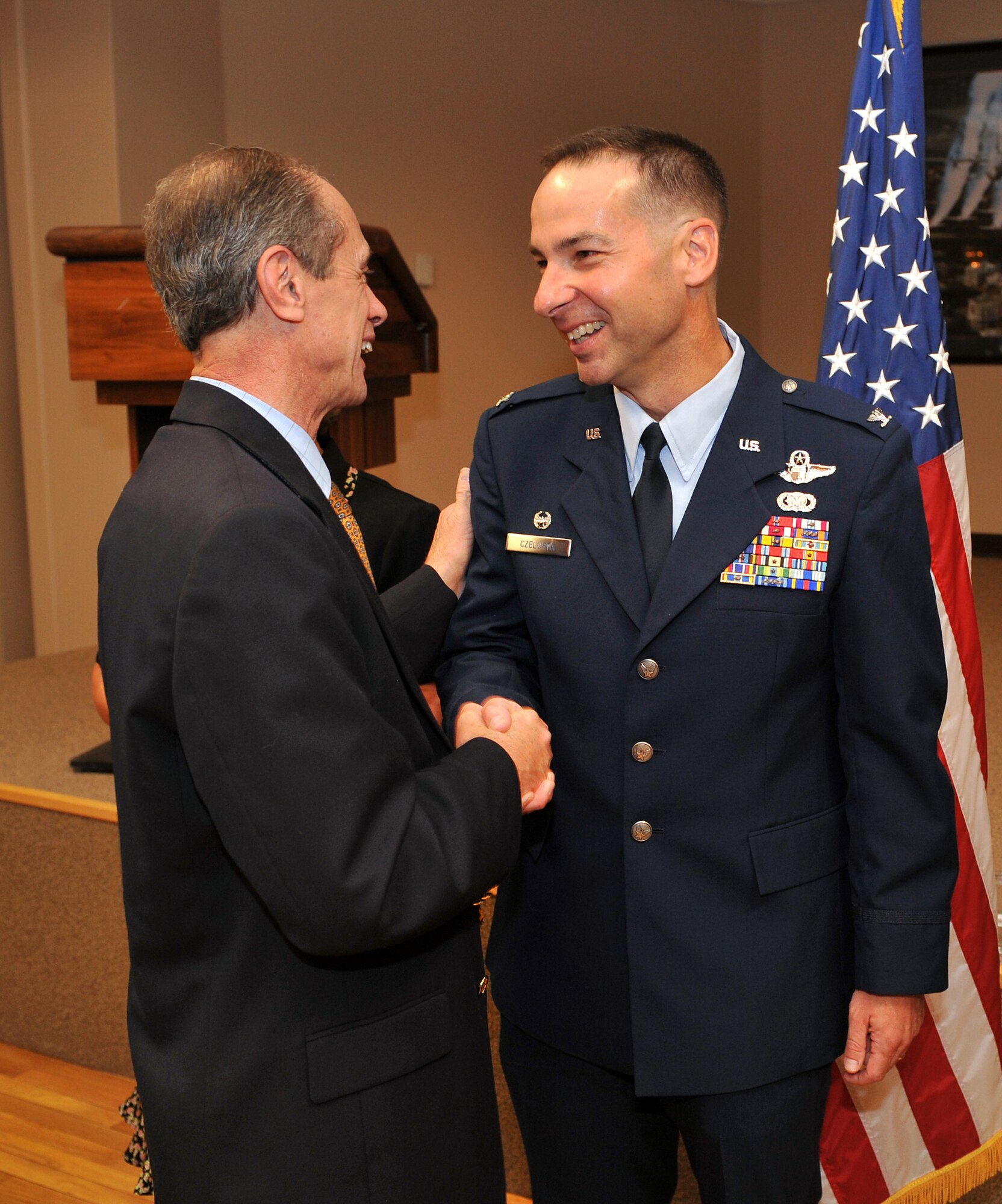 Col. Mark Czelusta, 314th Airlift Wing commander, shakes hands with Jacksonville Mayor Gary Fletcher during the 314th AW change-of-command post ceremony Aug. 20. Colonel Czelusta now leads a team of approximately 1,200 military and civilian professionals who form the C-130 "Center of Excellence" for tactical airlift. (U.S. Air Force photo by Staff Sgt. Chris Willis)