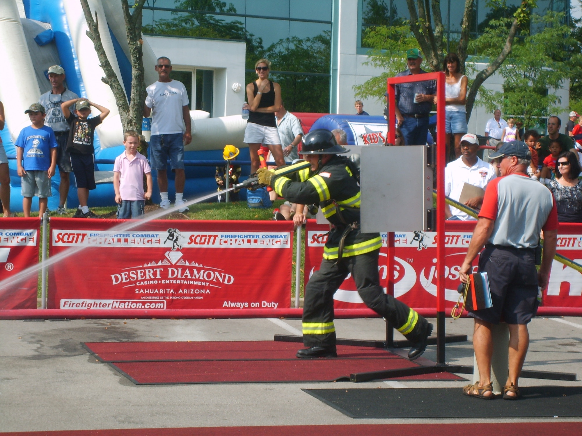 100812-F-0000T-002 Technical Sgt. Travis Mills, 20th Civill Engineer firefighter, drags a charged 1 3/4 fire hose 100 feet, running through spring loaded doors and knocking down a target. (U.S. Air Force photo/ Staff Sgt. Steven Thomas(Released)
