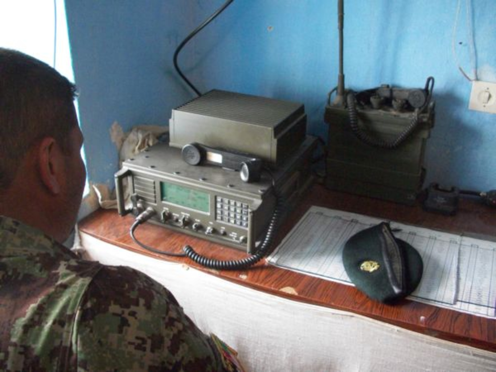 A member of the Afghan Air Force Communication squadron works a radio on the Afghan Air Force base in Kabul, Afghanistan.  (U.S. Military photo/RELEASED).
