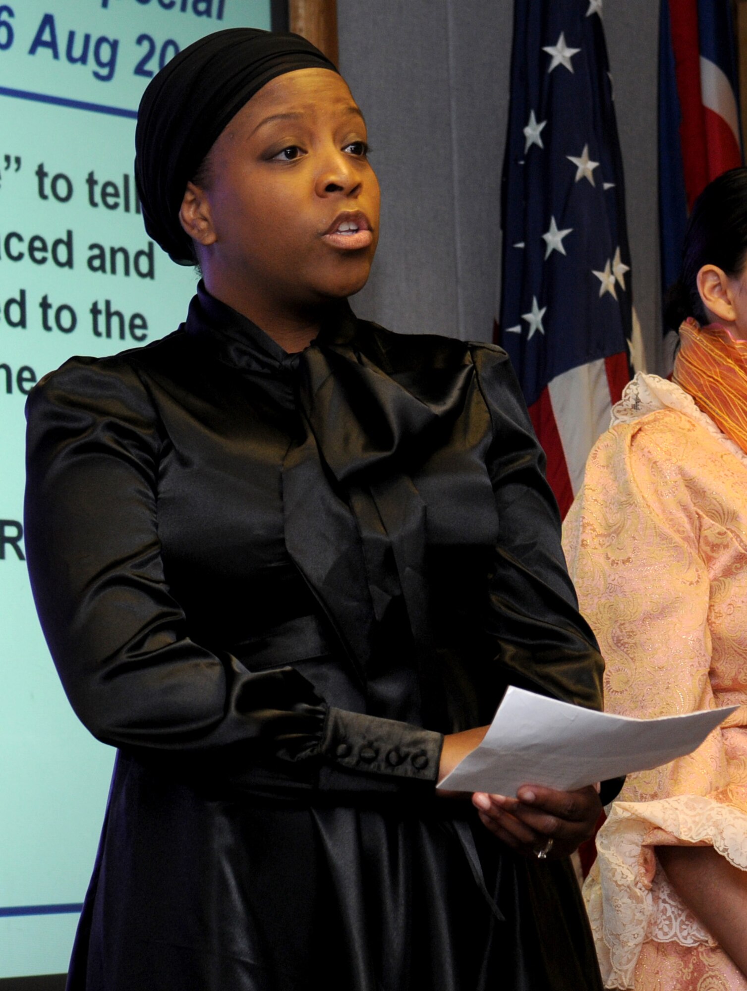 Tech. Sgt. Daydra Riggins portrays Sojourner Truth in observance of Women's Equality Day during a 100th Air Refueling Wing staff meeting here Aug. 25. Sergeant Riggins and four other Airmen will be portraying famous women at three locations around the base Aug. 26 to spread the word about challenges women faced leading up to the signing of the 19th Amendment to the Constitution. (U.S. Air Force photo/Staff Sgt. Jerry Fleshman)