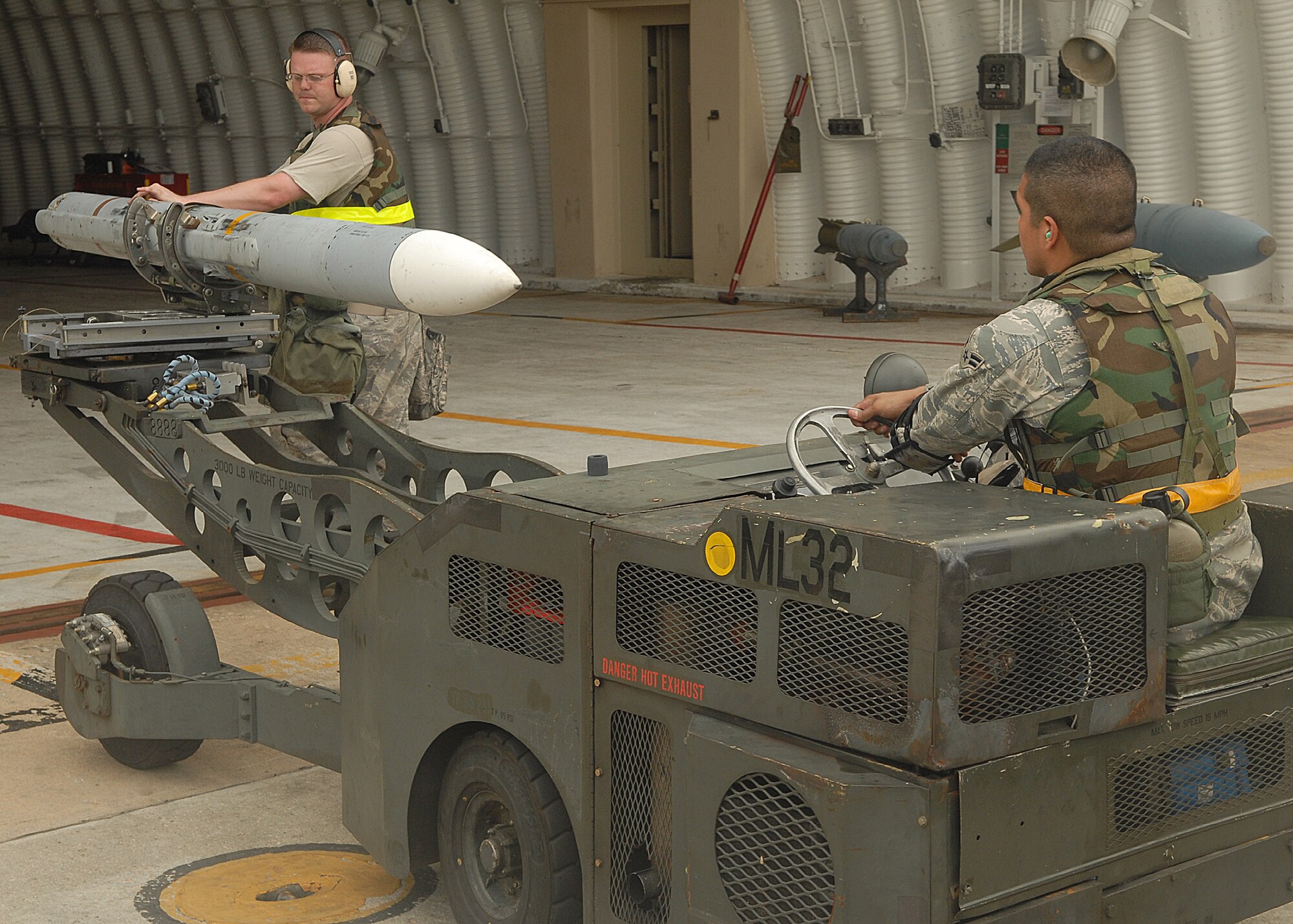 KUNSAN AIR BASE, Republic of Korea -- Weapons load crew members prepare to load an AIM-120 missile to an F-16 here Aug. 25, during exercise Beverly Midnight 10-03.  Members of load crews have to precisely and promptly load missiles for flight generation. (U.S. Air Force photo/Senior Airman Ciara Wymbs)