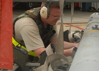 KUNSAN AIR BASE, Republic of Korea -- Staff Sgt. Thomas O’Boyle, 80th Aircraft Maintenance Squadron weapons load crew member, prepares a missile for movement to an F-16 here Aug. 25. Sergeant O’Boyle is part of a three-man load crew in charge of loading weapons to aircraft before flight during exercise Beverly Midnight 10-03. (U.S. Air Force photo/Senior Airman Ciara Wymbs)  